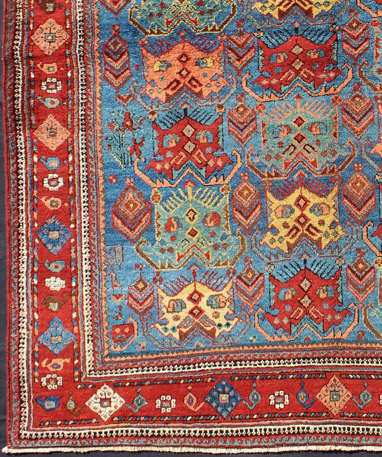 Square shape Antique Persian Afshar Rug in Blue Background, Terracotta Red Border, Light Green, vivid yellow, salmon and ivory. Bold geometry, rich symbolism, and vivid singular coloration contribute to the beauty of this stunning piece. Keivan