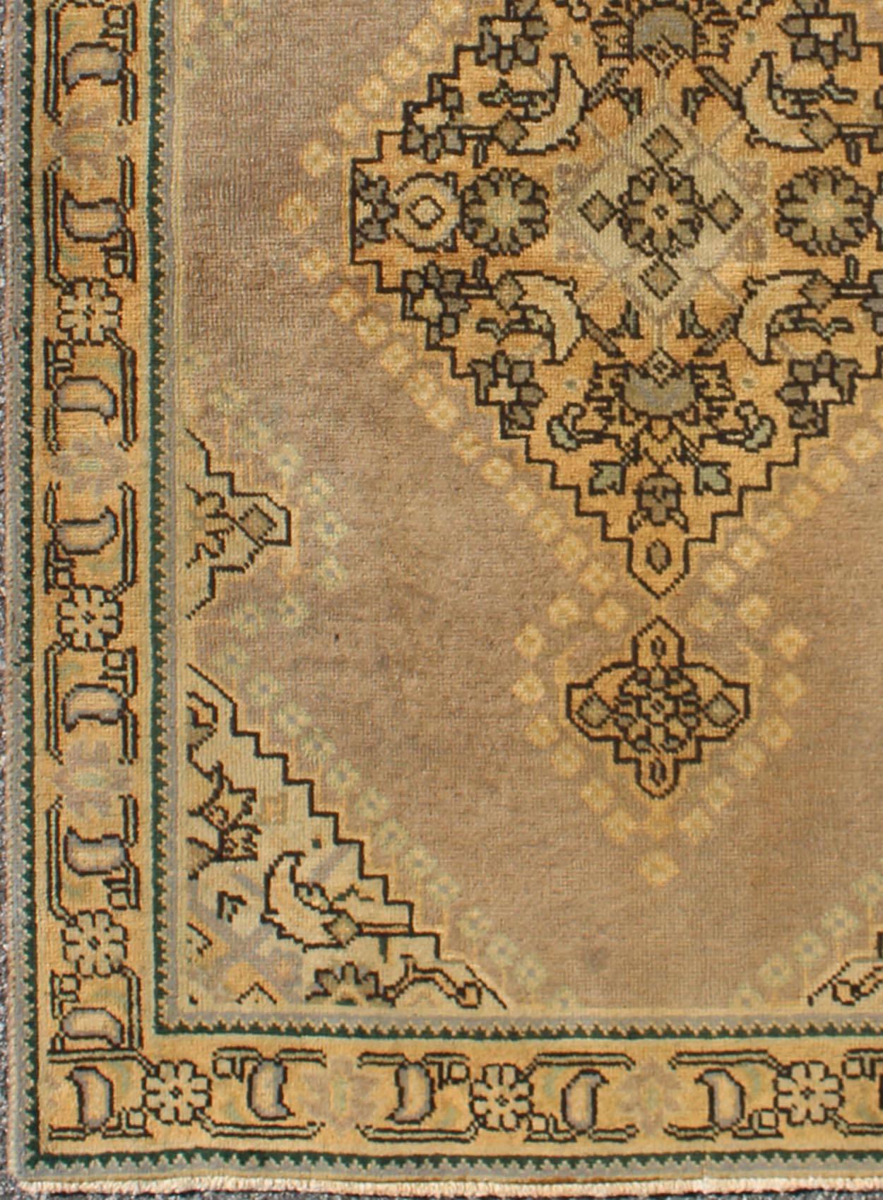 This vintage Persian rug features a center medallion design in a neutral color palette with brown outlines. 
Measures 3'0 x 5'1.
