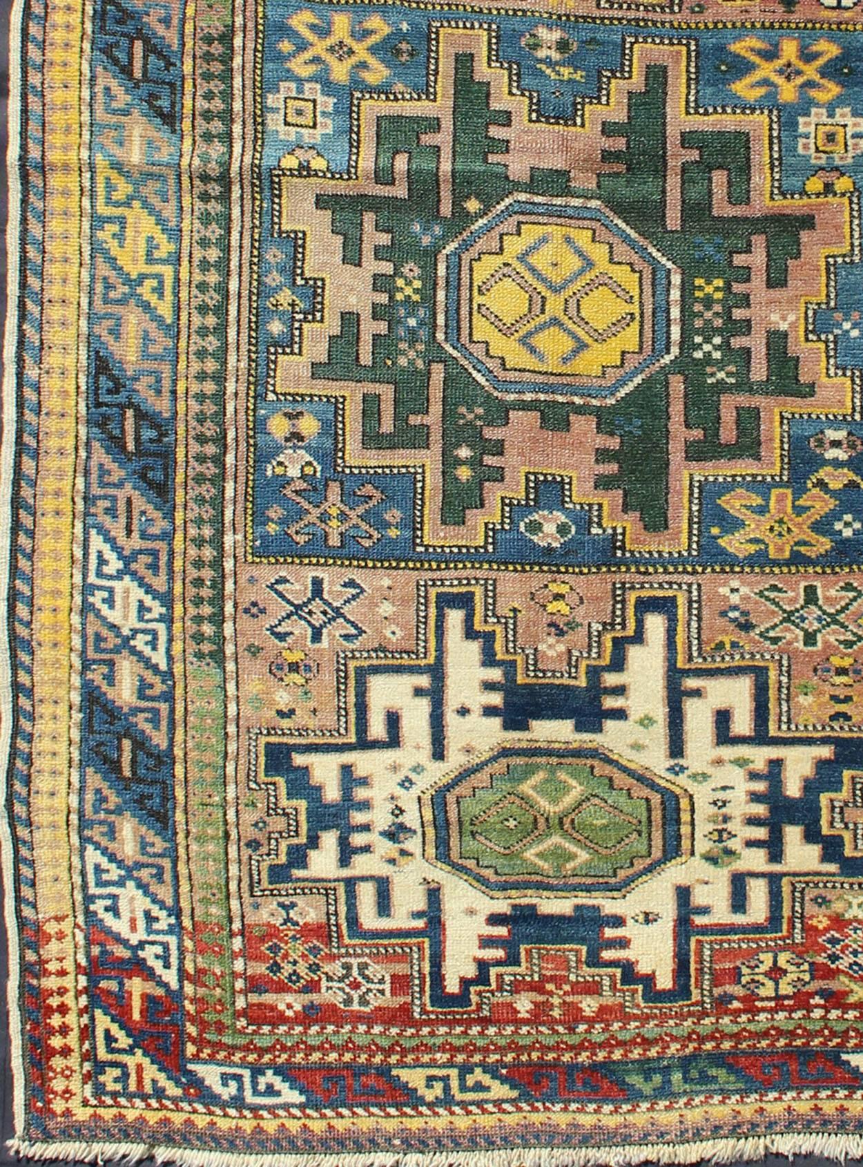 Measures: 3'5'' x 5'7''.
Antique Colorful Kuba Caucasian Rug with Star Medallions in Green, Blue, and Yellow.  This wonderfully colored Kuba rug from the southern Caucasus features three star medallions and an octagonal shield ornament. This motif