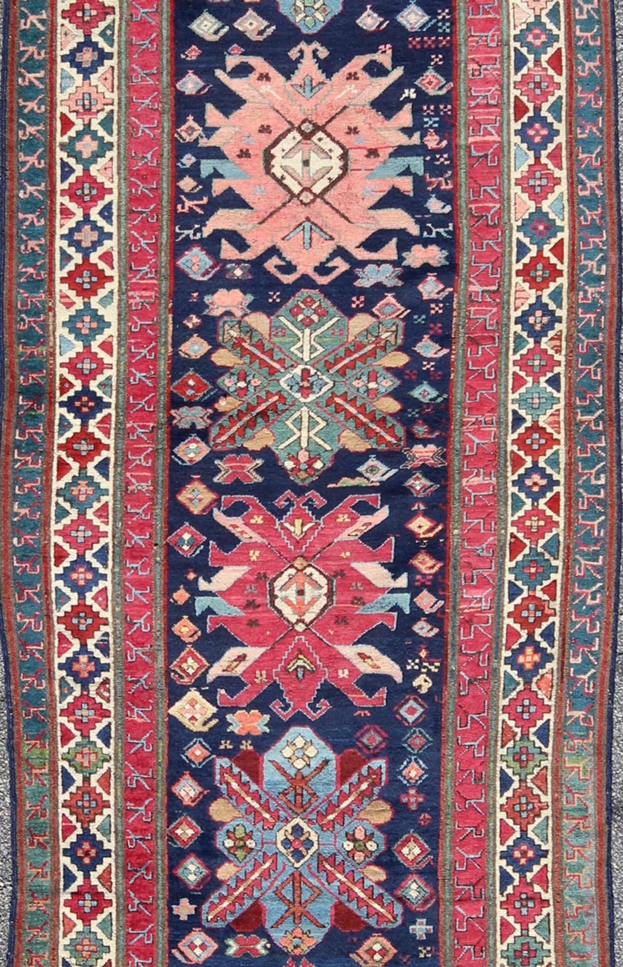 Persian Antique Late 19th Century Kazak Caucasian Runner in Navy Blue Background For Sale