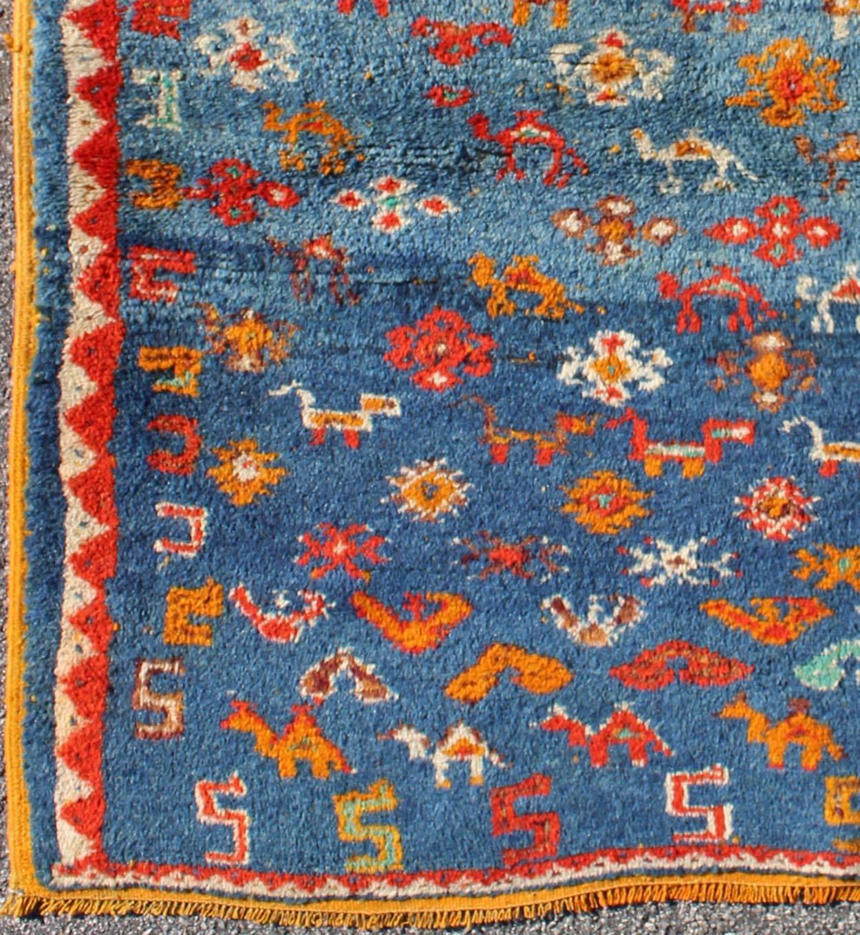 Vintage Moroccan Rug with Beautiful Blue Background.
This charming vintage Moroccan rug features a wonderful blue background with orange accents. The field design contains colorful peacocks and birds.
Measures: 3'5 x 4'.