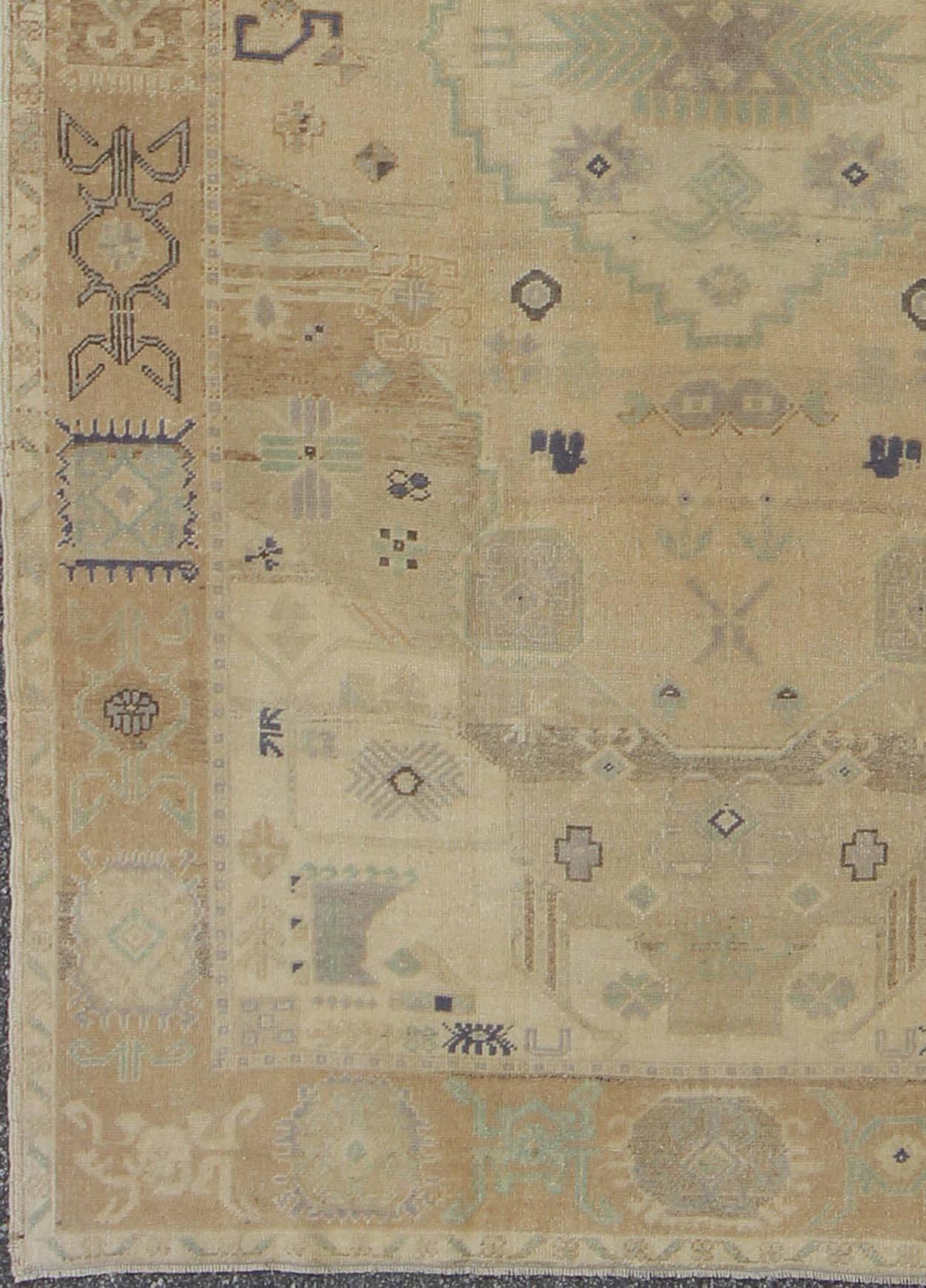 This stunning Turkish Oushak features an open, large-scale, geometric design on taupe and tan background with muted blues and a brown outlines.
Measures: 5'6 x 9'3.