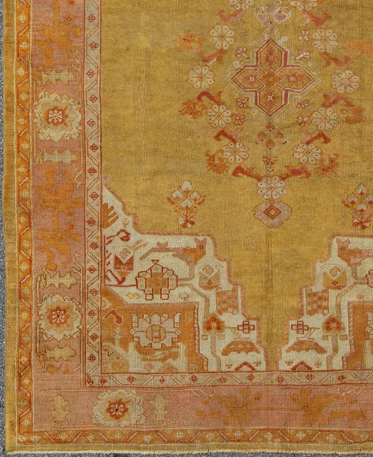 Antique Oushak rug in yellow green background, pink border, red and orange accents, Keivan Woven Arts/rug / H8-0403, Green antique Oushak 

Measures: 7'10 x 11'3.

This beautiful antique Turkish Oushak showcases an elegant combination of yellow