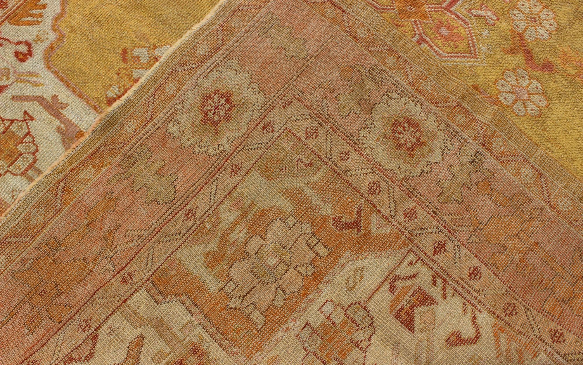Antique Oushak Rug in Yellow Green Background, Pink Border, Red & Orange Accents In Good Condition For Sale In Atlanta, GA