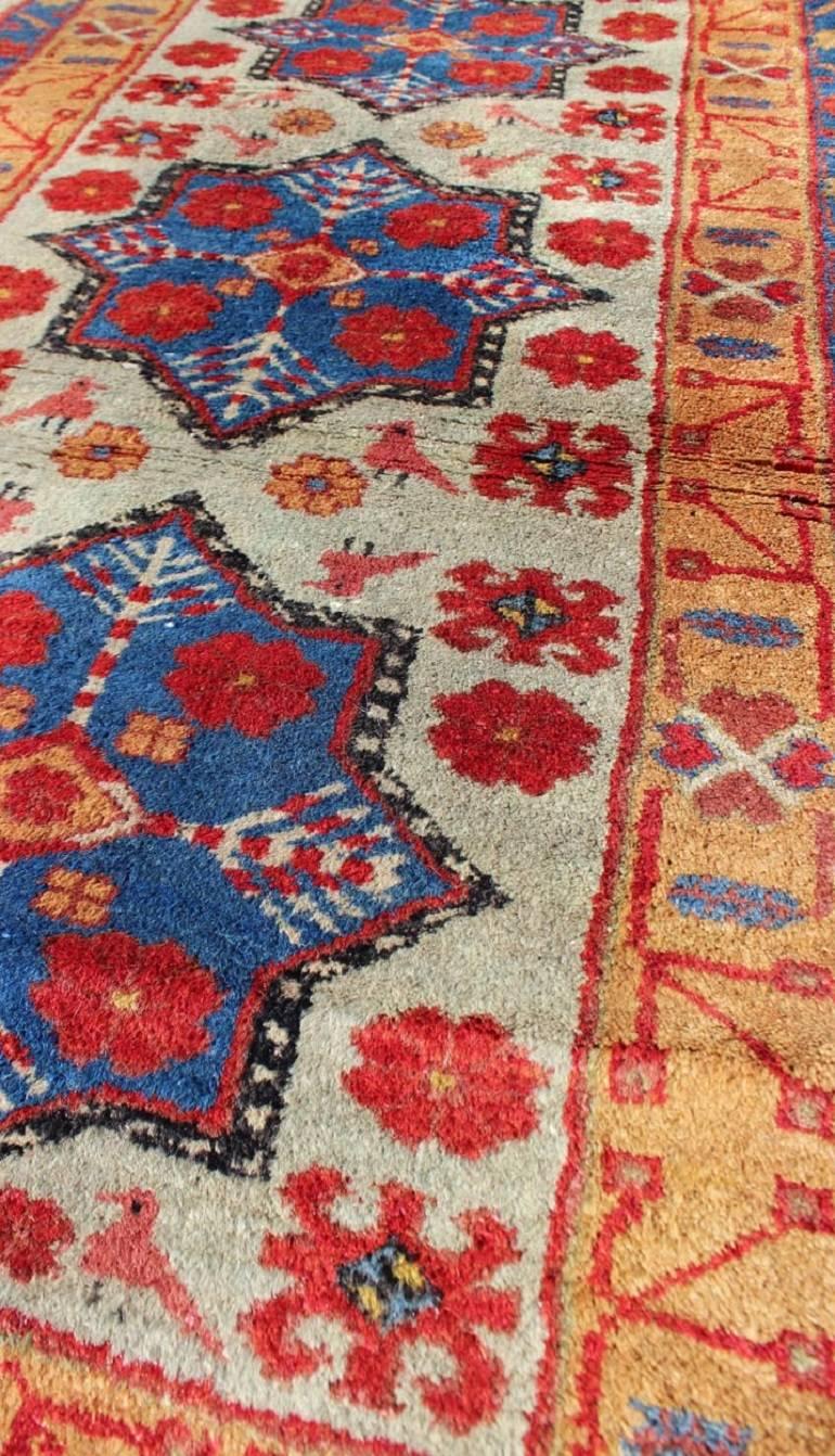 Hand-Knotted Vintage Turkish Rug with Star Design in light Green, Orange, Red & Blue   For Sale