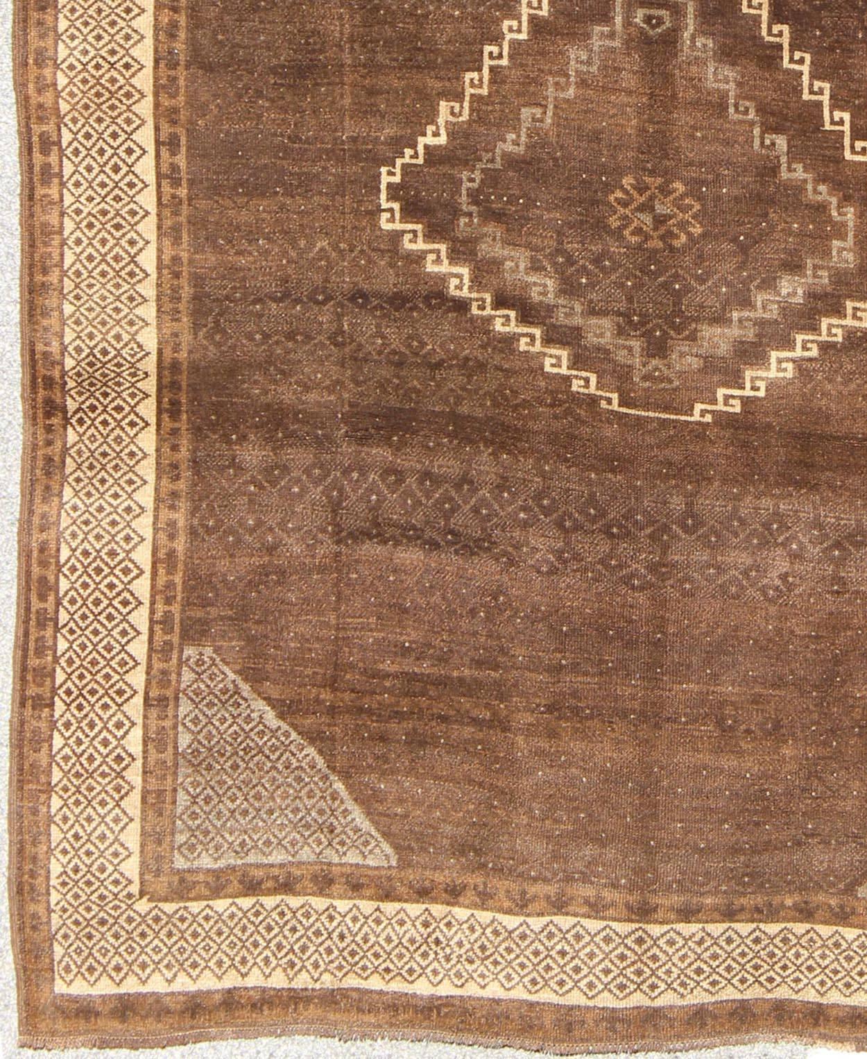 Measures: 7'7 x 10'4.
This wonderful Turkish rug, from eastern Turkey, displays a chocolate brown background with a small, repeating geometric pattern in the background and border.

Vintage Turkish Kars rug with a Modern Design in shades of brown