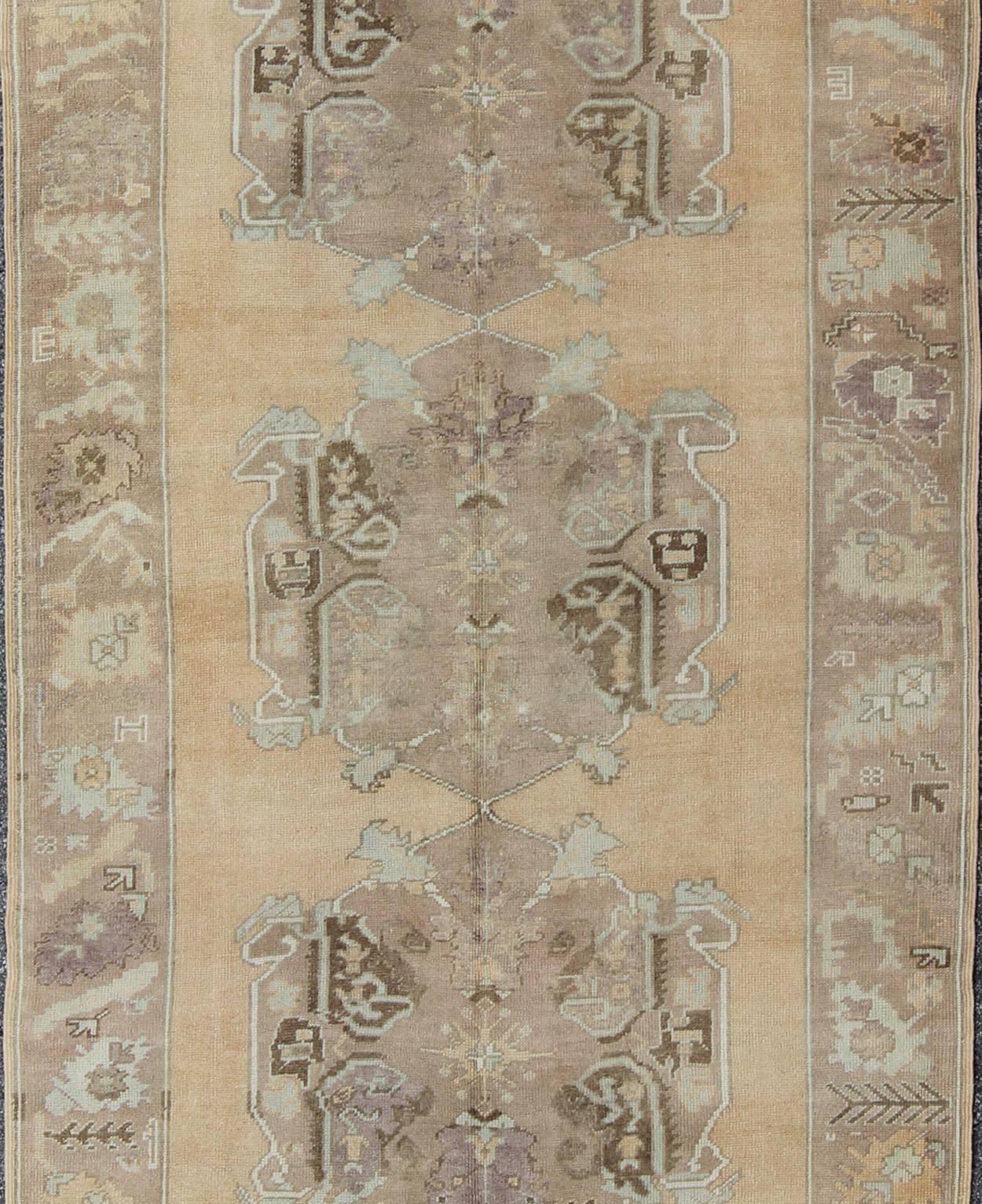 Turkish Vintage Oushak Rug with Three Central Medallions Set on Faint Sand-Colored Field For Sale