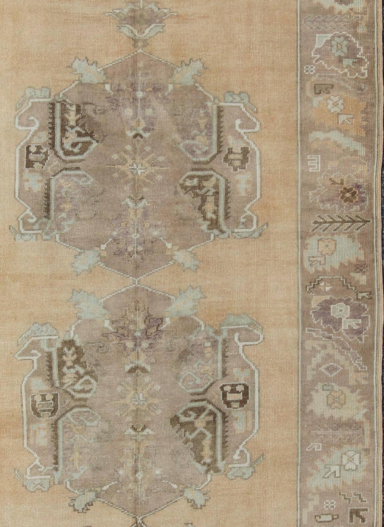 Hand-Knotted Vintage Oushak Rug with Three Central Medallions Set on Faint Sand-Colored Field For Sale