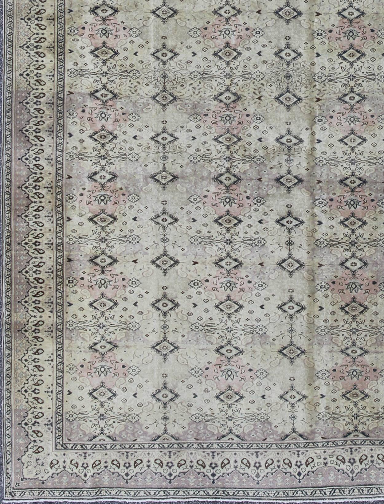 Stylized diamond motifs are featured in a repeating pattern on this vintage Sivas wool rug. A blend of Persian inspiration and Turkish design creates a unique, dynamic aesthetic in this one-of-a-kind piece, while its soft, ivory ground plays host to