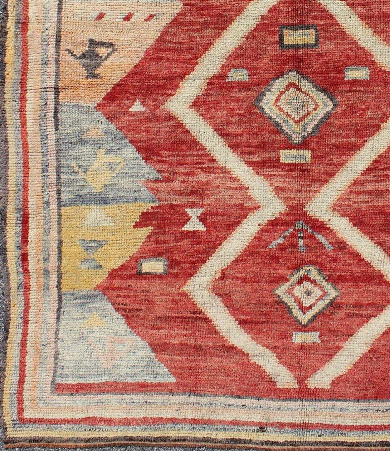 Turkish Tulu Rug with Diamond Shapes Among Geometric Motifs 
 rug/ enc-92044

This Tulu carpet contains three diamond shapes laid across a red-colored field and enclosed within surrounding geometric elements. Accent colors include yellow, orange,