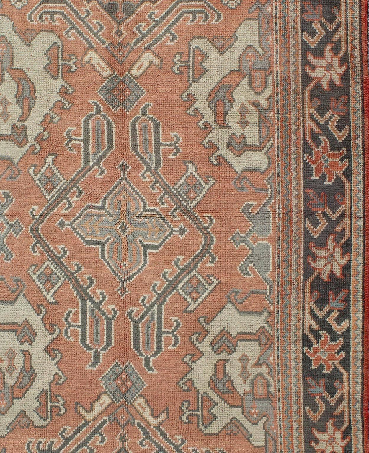 Hand-Knotted Antique Oushak Rug from Turkey with Central Medallion and Sub-Geometric Elements For Sale