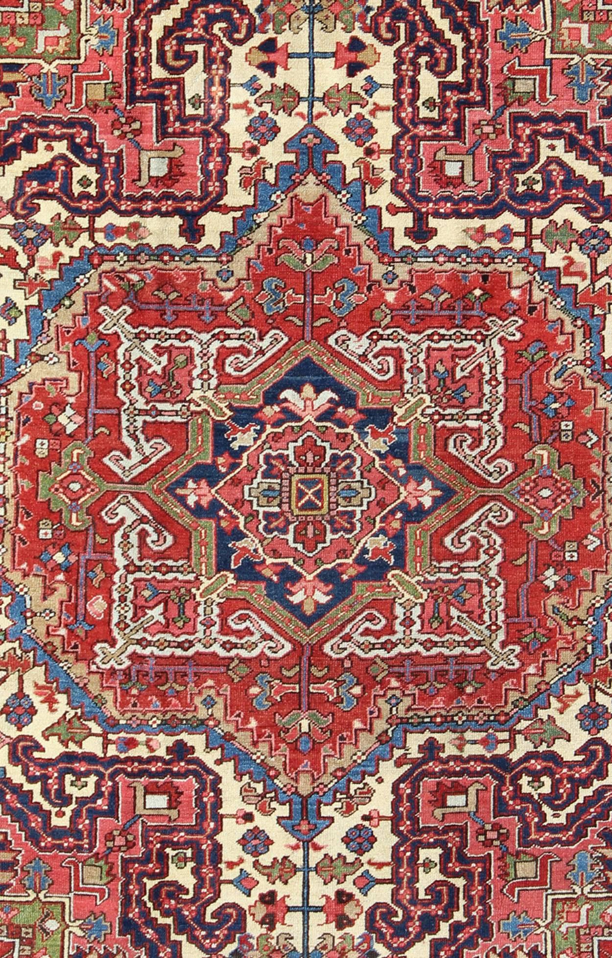 Heriz Serapi Antique Persian Heriz Carpet with Stylized Central Medallion in Warm Hues of Red