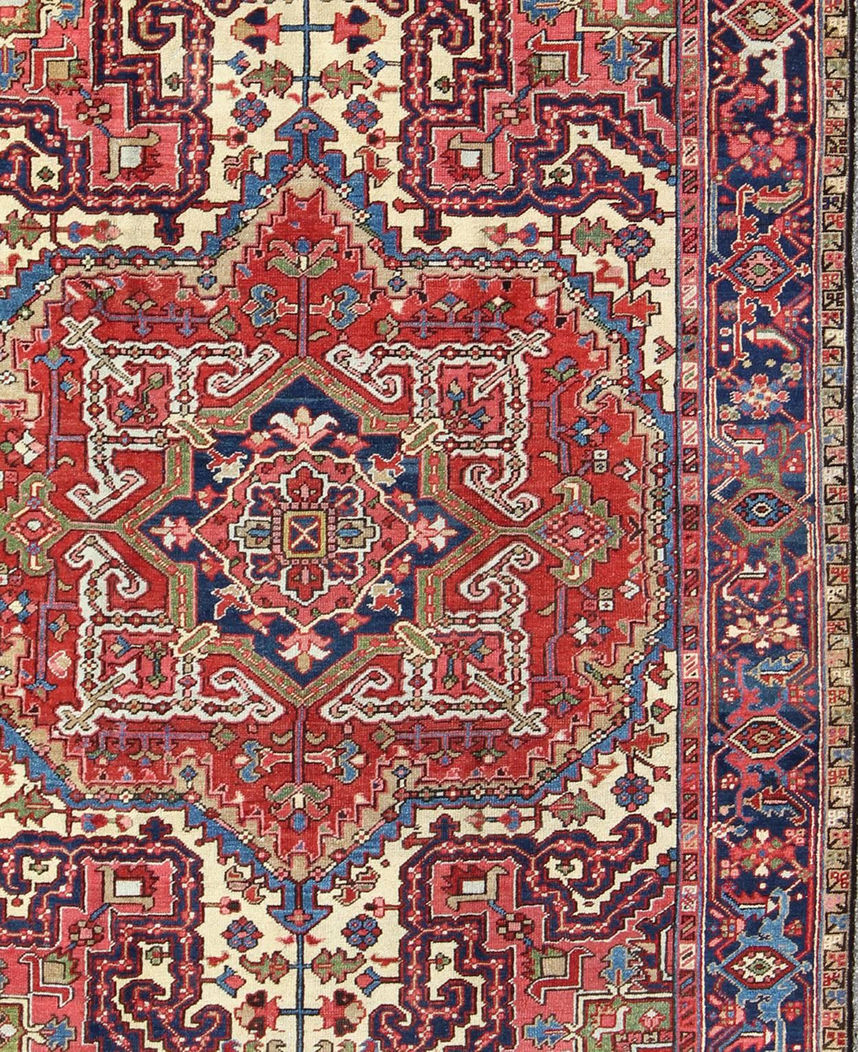Hand-Knotted Antique Persian Heriz Carpet with Stylized Central Medallion in Warm Hues of Red
