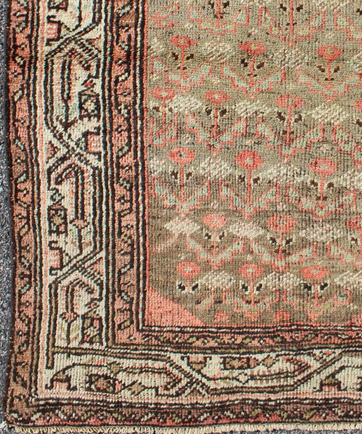 This antique Persian Hamadan carpet from early 20th century Iran features an all-over tribal pattern set on a distinct orange background, which is surrounded by a complementary border in shades of orange and ivory.
Measures: 3'4 x 4'10.