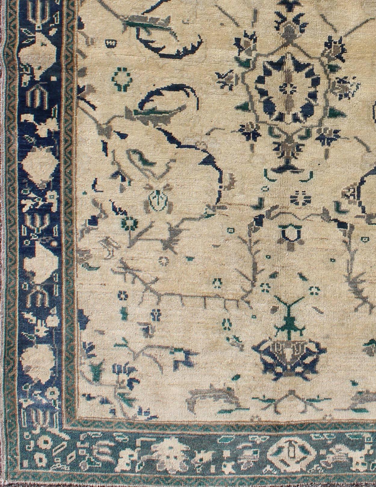 Turkish Oushak Rug Vintage with Vining Florals 
rug/en-92194,  origin/turkey

This Oushak rug features a unique blend of colors and an intricately beautiful design. The central medallion is complemented by a symmetrical set of floral and botanical