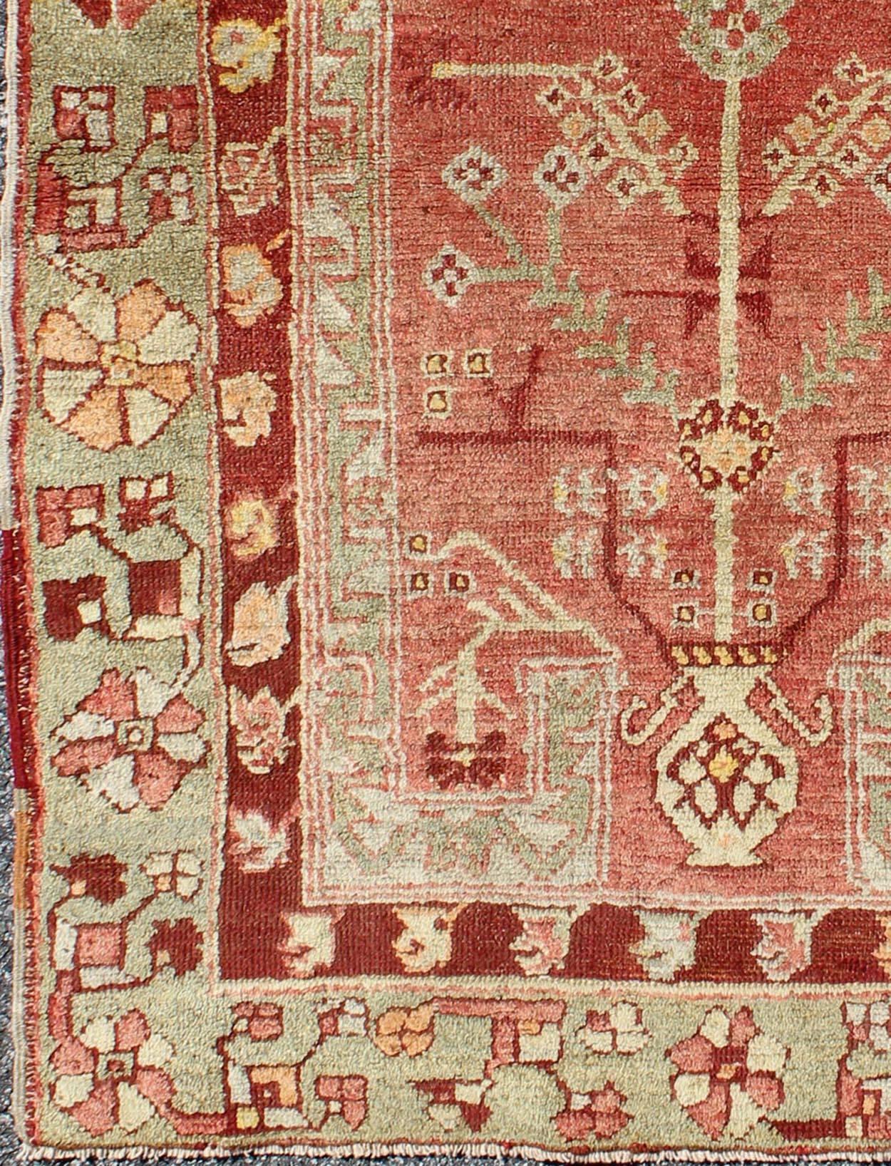 Antique Oushak Rug From Turkey With Directional Tribal Motifs in Soft Pink Red, Green.     

Antique Oushak Rug Turkey with Tree and Stems, geometric border & Tribal Motifs  Keivan Woven Arts/rug/TU-EYP-1,  origin/Turkey, Circa, 1910's 

Measures: