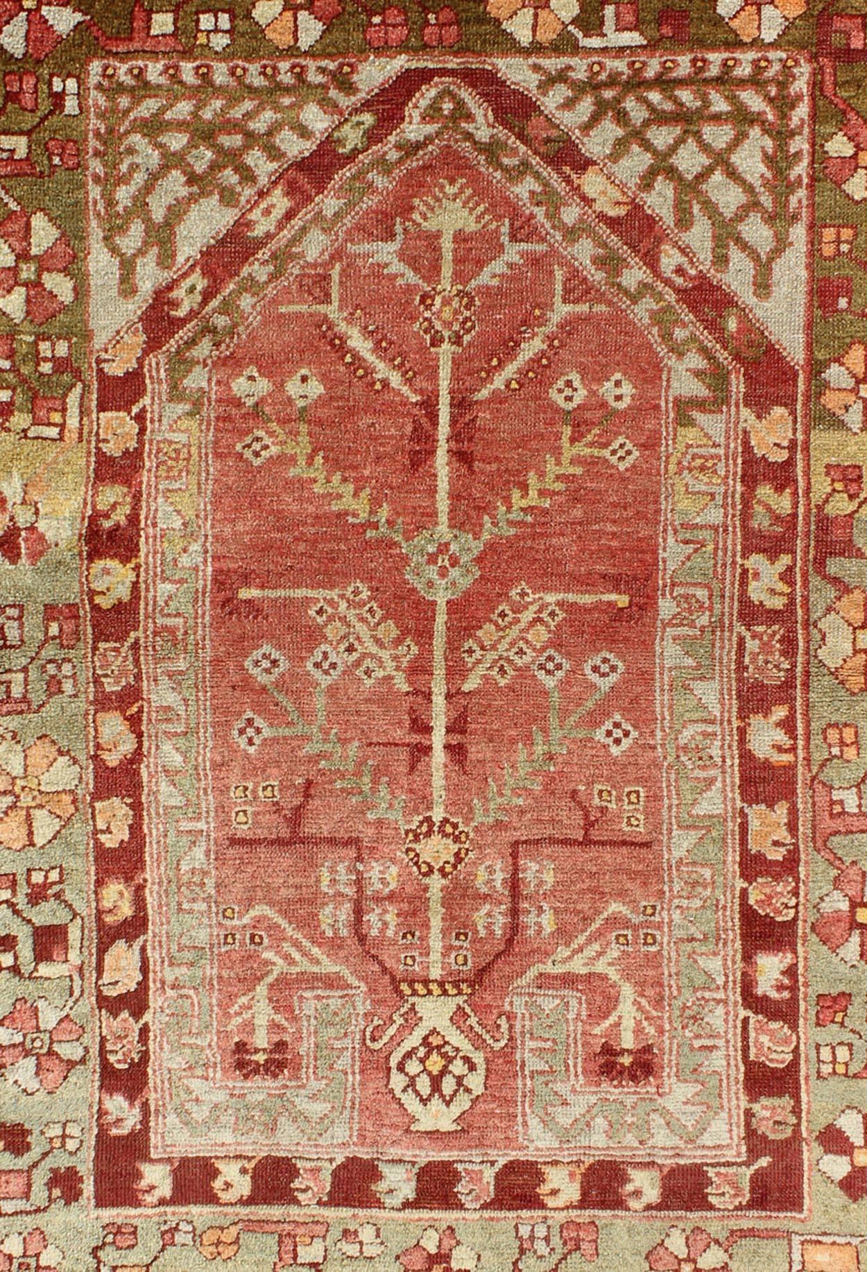 Turkish Antique Oushak Rug with Directional Tribal Motifs in Soft Pink Red & Green For Sale