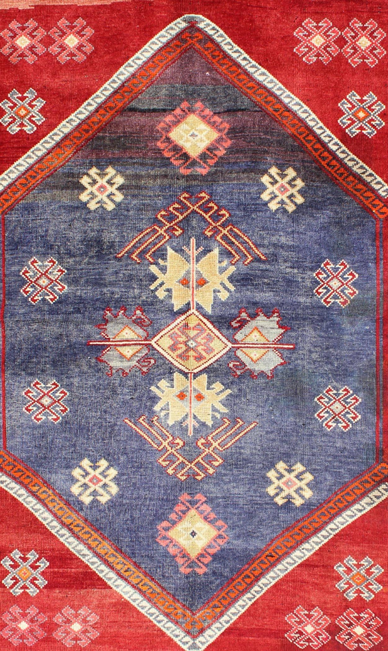 Hand-Knotted Vintage Turkish Oushak Rug with Geometric Design Set on Blue and Red Background For Sale
