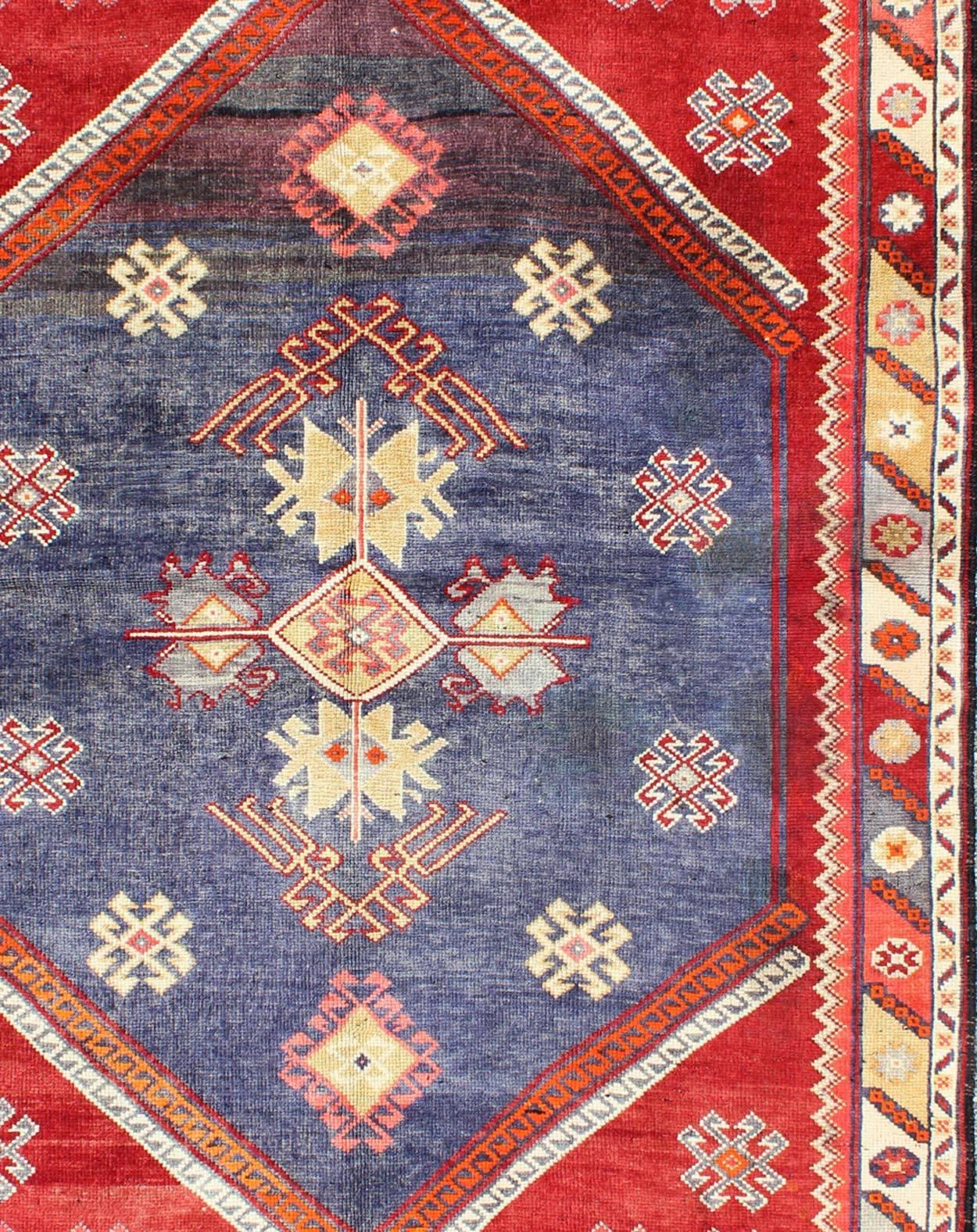 Vintage Turkish Oushak Rug with Geometric Design Set on Blue and Red Background In Excellent Condition For Sale In Atlanta, GA