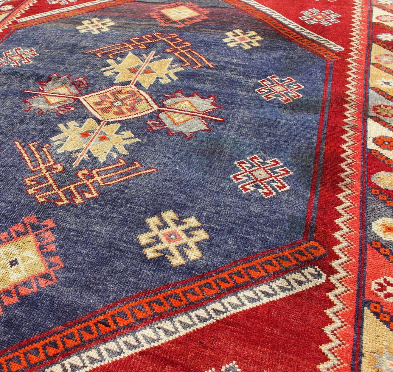 20th Century Vintage Turkish Oushak Rug with Geometric Design Set on Blue and Red Background For Sale