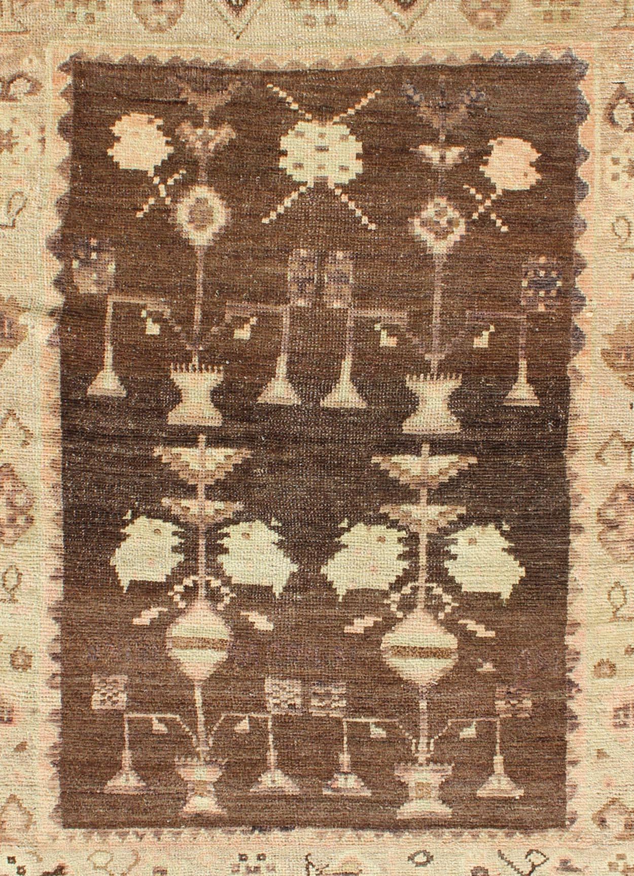 Hand-Knotted Vintage Turkish Oushak Carpet with Tribal Design Set on Brown Background For Sale