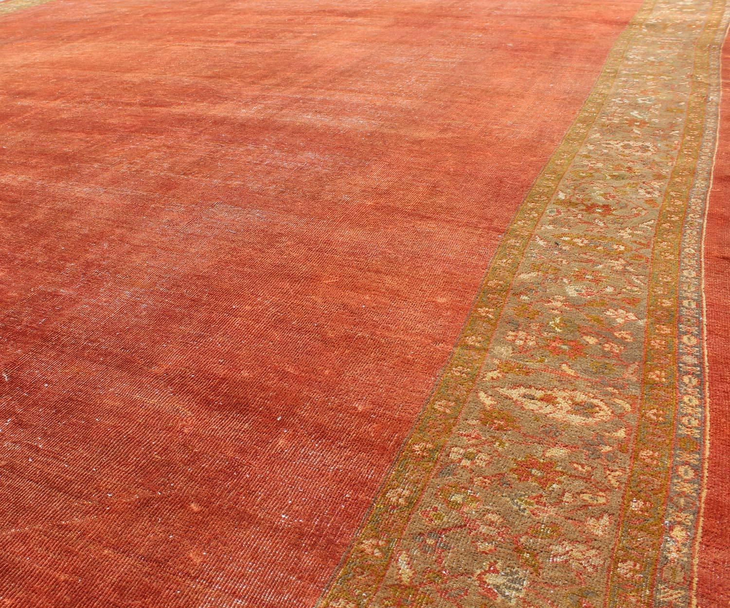Antique Sultanabad Carpet with Open Red Field and Yellow-Green Floral Border In Distressed Condition For Sale In Atlanta, GA