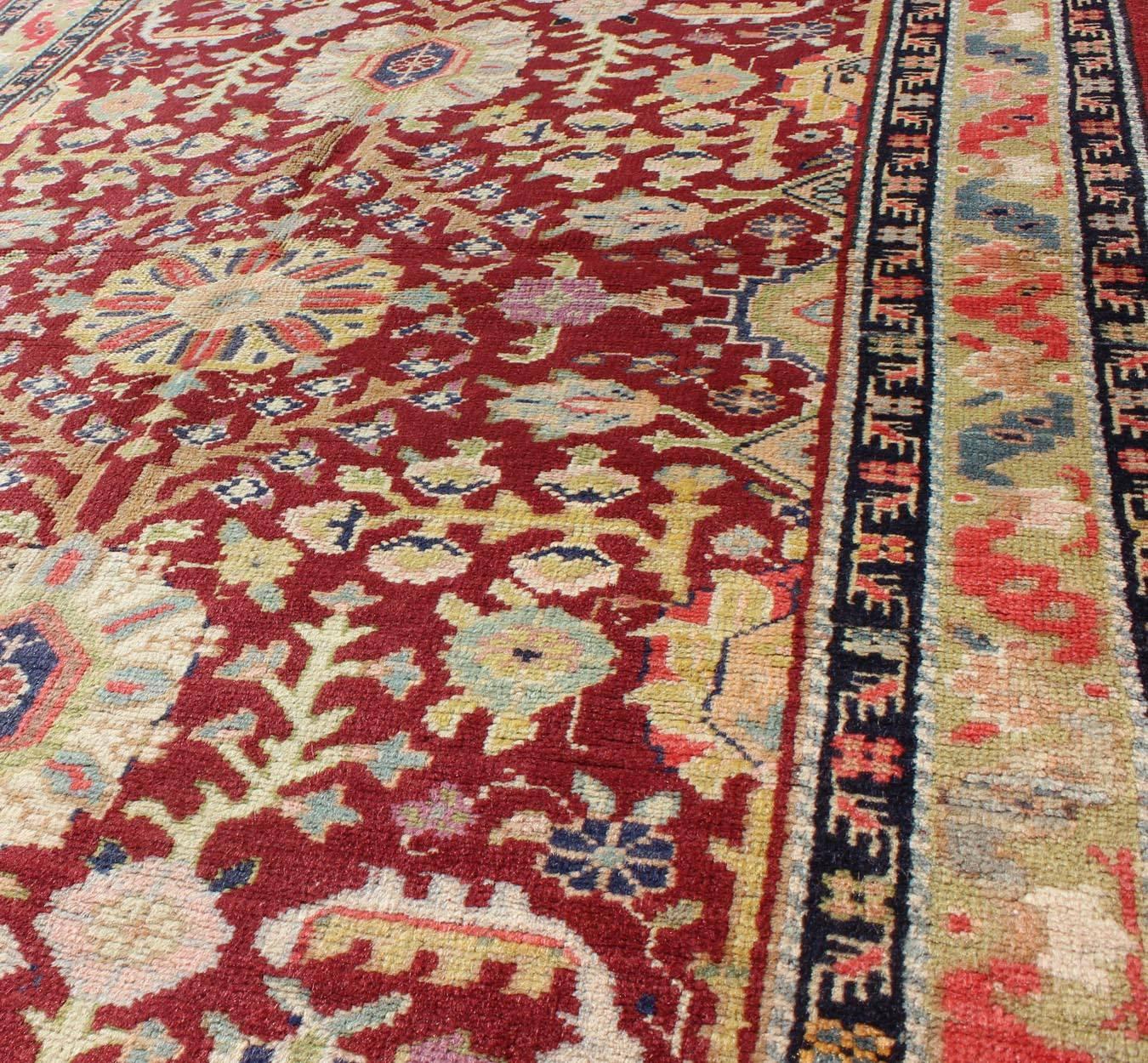 Mid-20th Century Colorful Turkish Oushak Carpet with Scattered Vines and Flowers on a Red Field For Sale