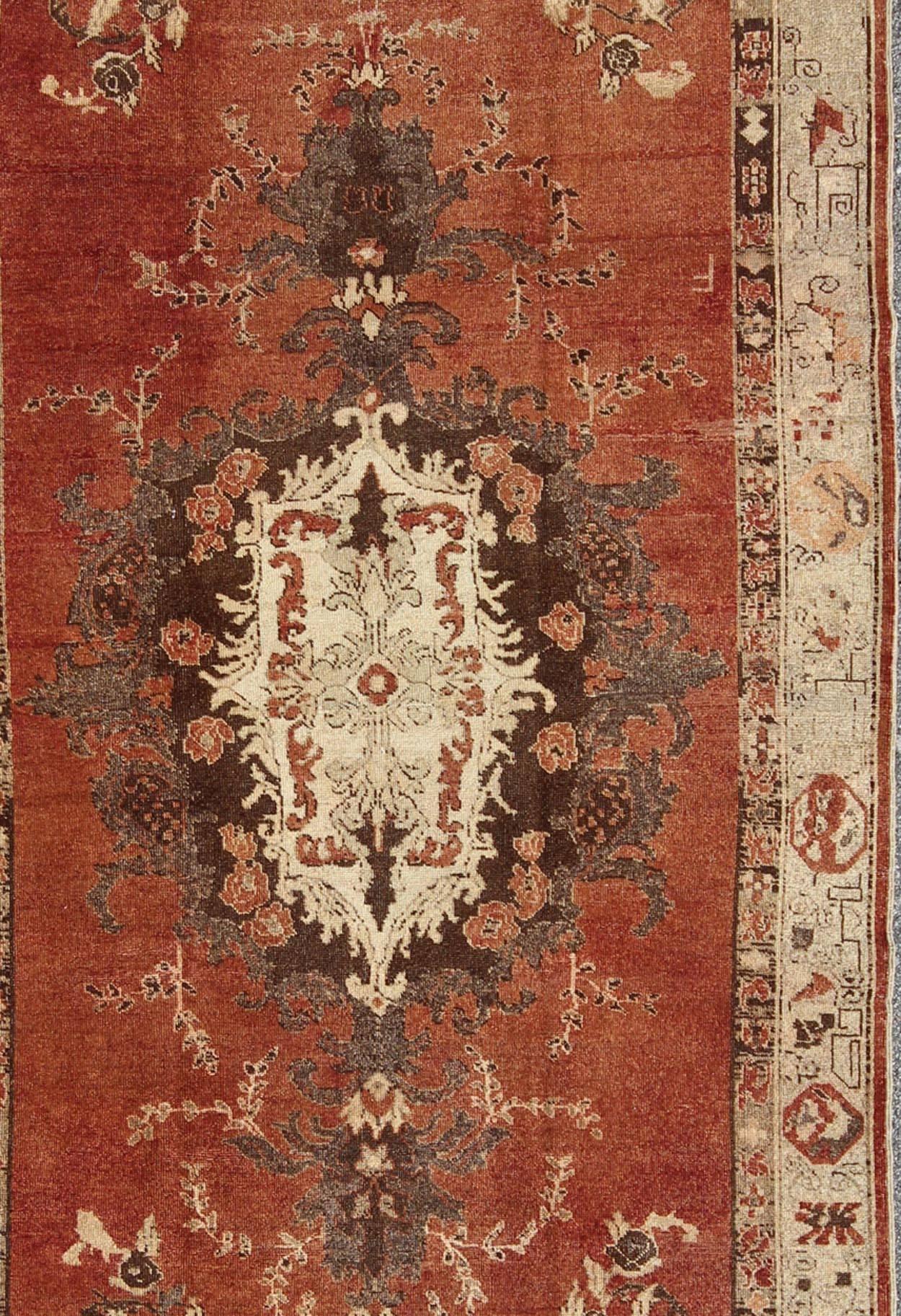 Hand-Knotted Vintage Oushak Carpet from Turkey with Faint Red Field and Floral Medallion For Sale