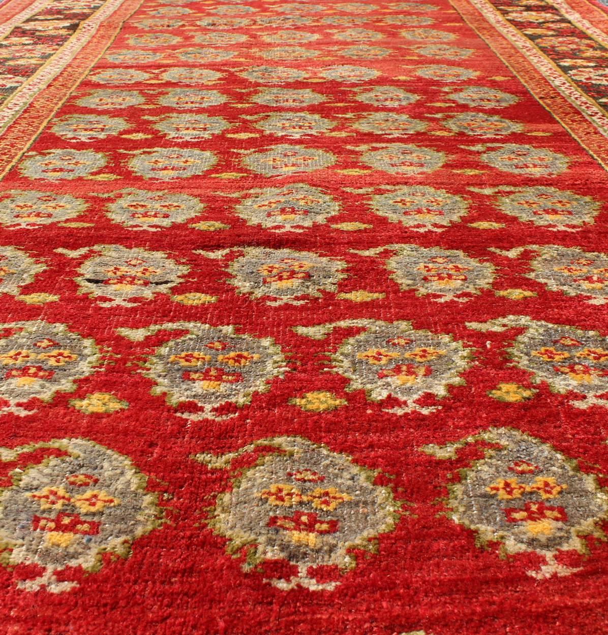 Wool Vintage Turkish Oushak Carpet with All-Over Paisley Design and Central Red Field For Sale