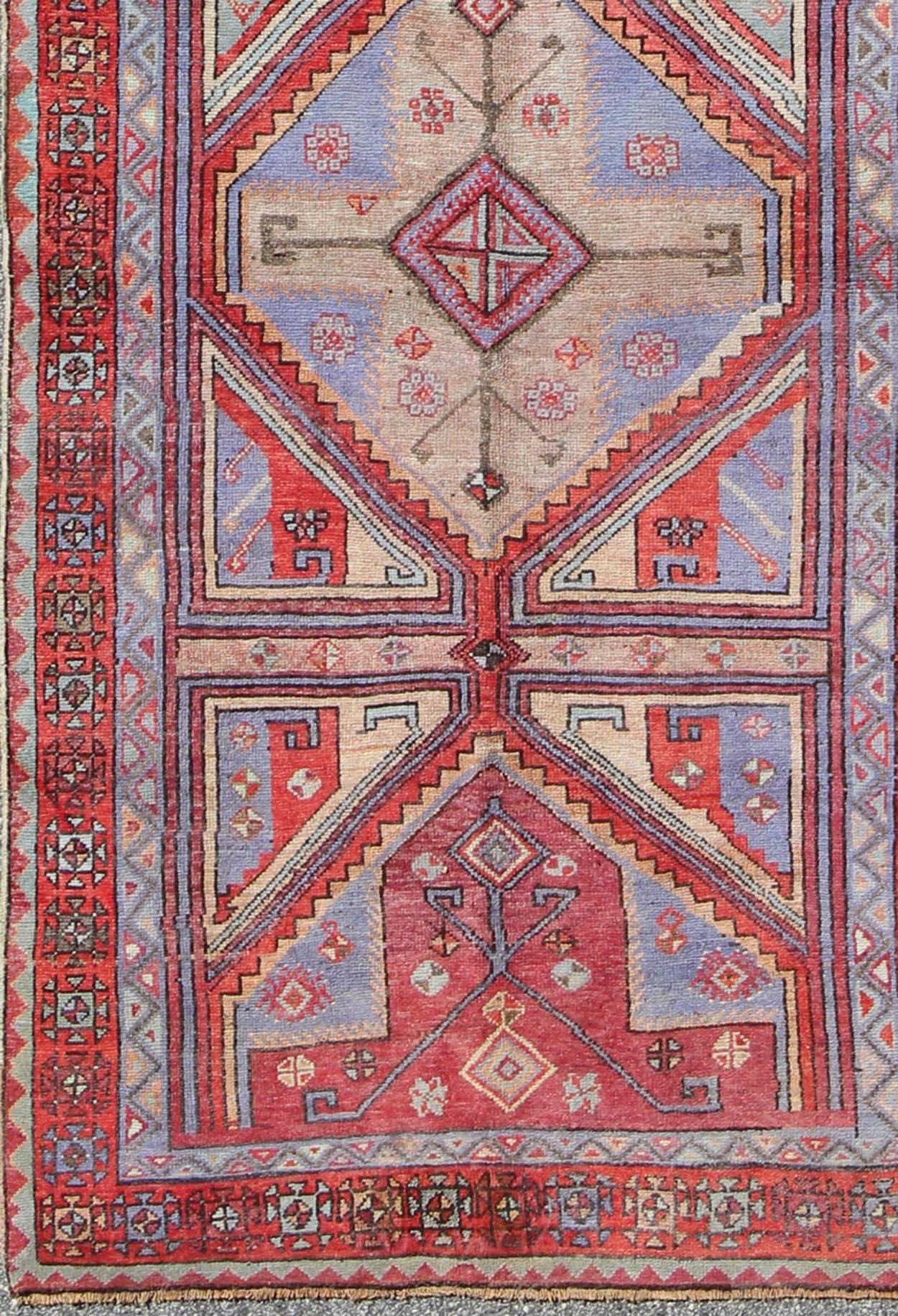 Vivid and Colorful Oushak Runner with Repeating Diamond Medallions  rug-tu-ugu-136008  origin/turkey

This Turkish Oushak runner features a repeating medallion design. Colors include bright and soft red, mint green, taupe, and light purple. Turkish
