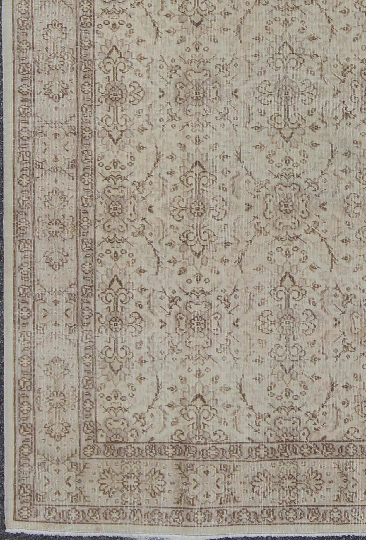 Vintage Turkish oushak carpet with botanical motifs set on an ivory ground vintage oushak. Keivan Woven Arts / Rug/EN-140567. 

The design of this beautiful vintage Oushak rug from mid-20th century Turkey is enhanced by its lustrous wool. The