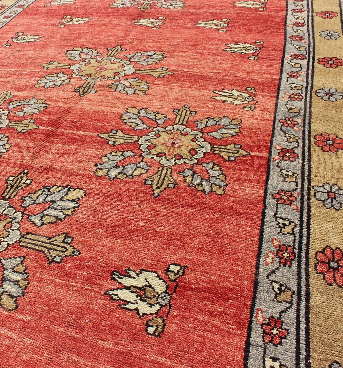 20th Century Vintage Turkish Oushak Carpet with Flowers in the Central Field and Borders For Sale