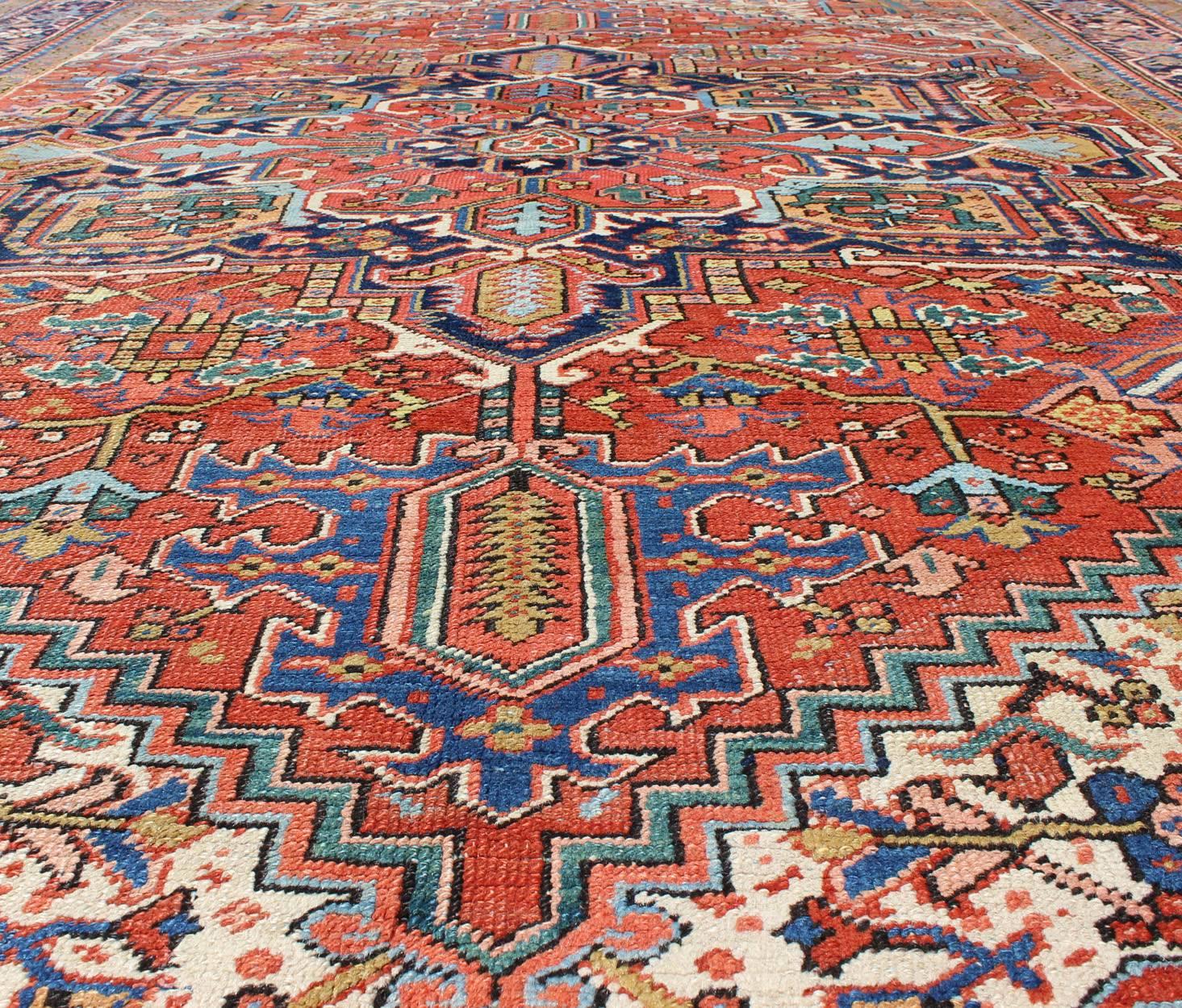 Early 20th Century Antique Colorful Persian Heriz Rug with Geometric Patterns and Intricate Design For Sale