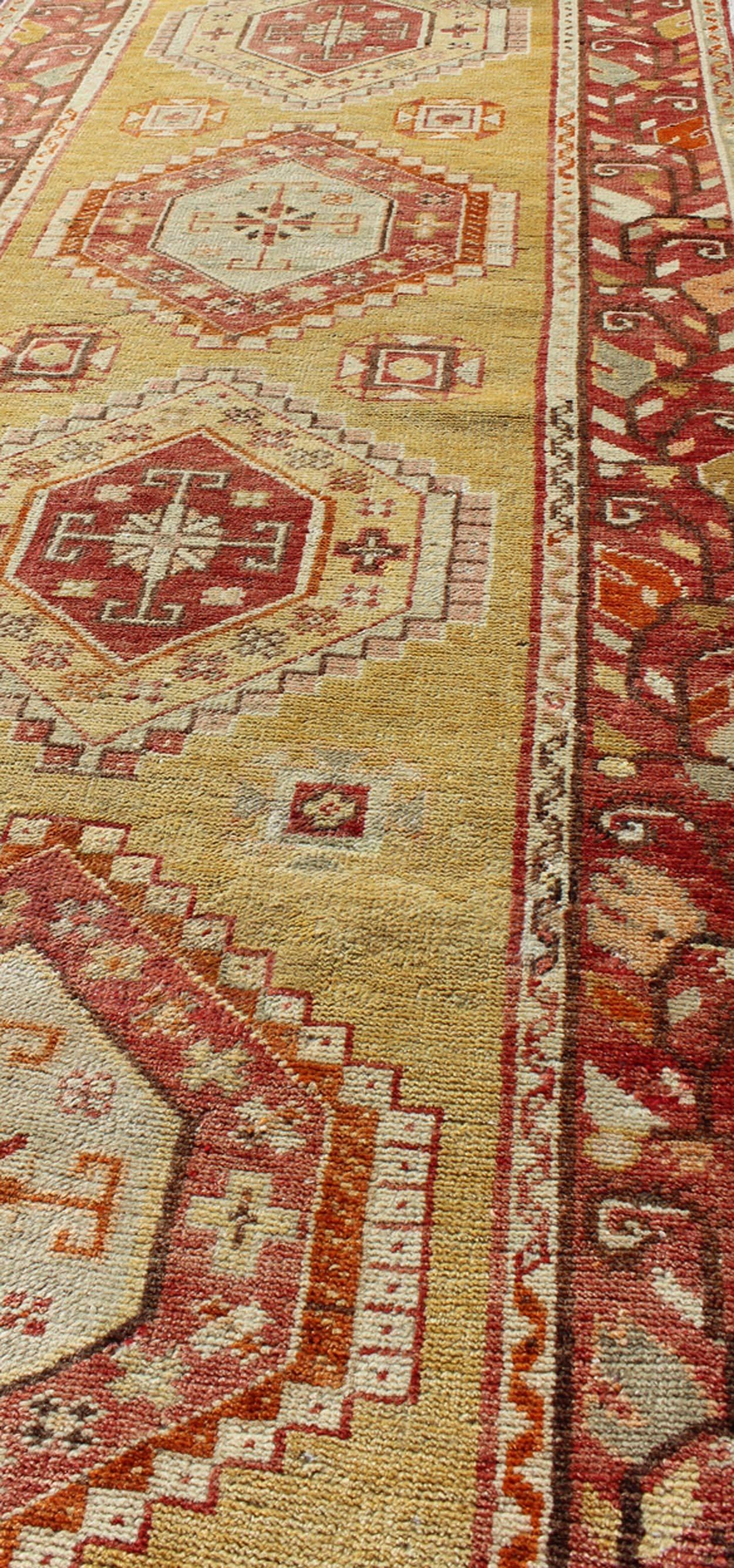 Wool Antique Turkish Oushak Runner with Geometric Medallions in Yellow Background  For Sale