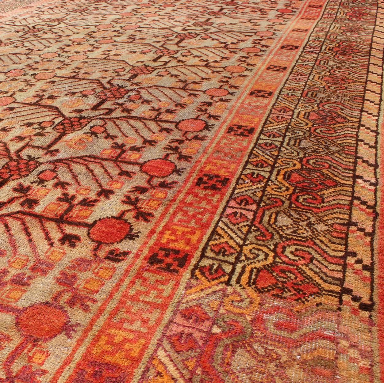 20th Century Large Khotan Antique Rug with Pomegranate Design in Taupe, Green, Red and Brown For Sale