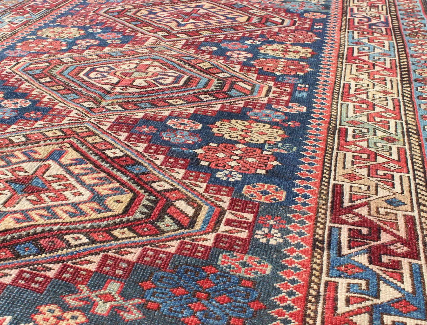 Hand-Knotted Antique Kazak Rug with in Multi Colors and Indigo Background For Sale