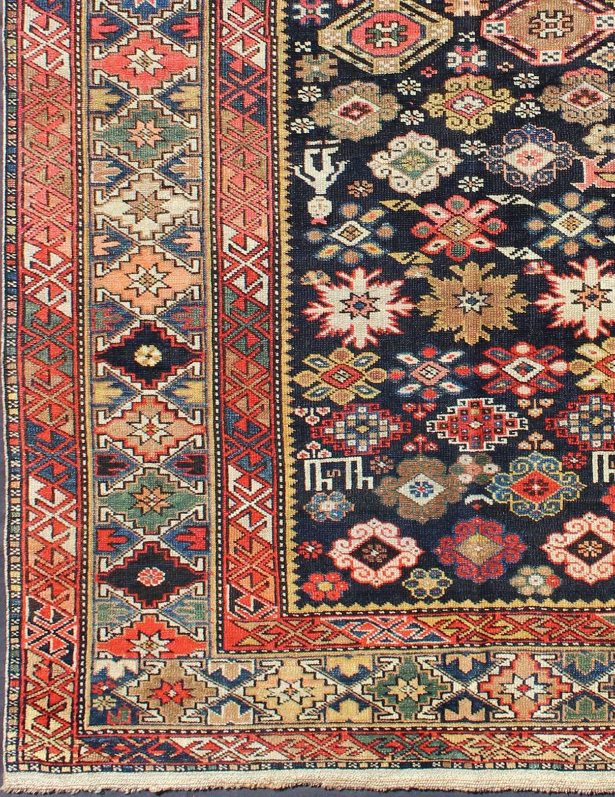 This Kuba rug from the southern Caucasus features many diamond medallions in the central field surrounded by multiple borders of geometric design. The diagonal coloring and arrangement of the field ornaments is heightened by the colorful design of