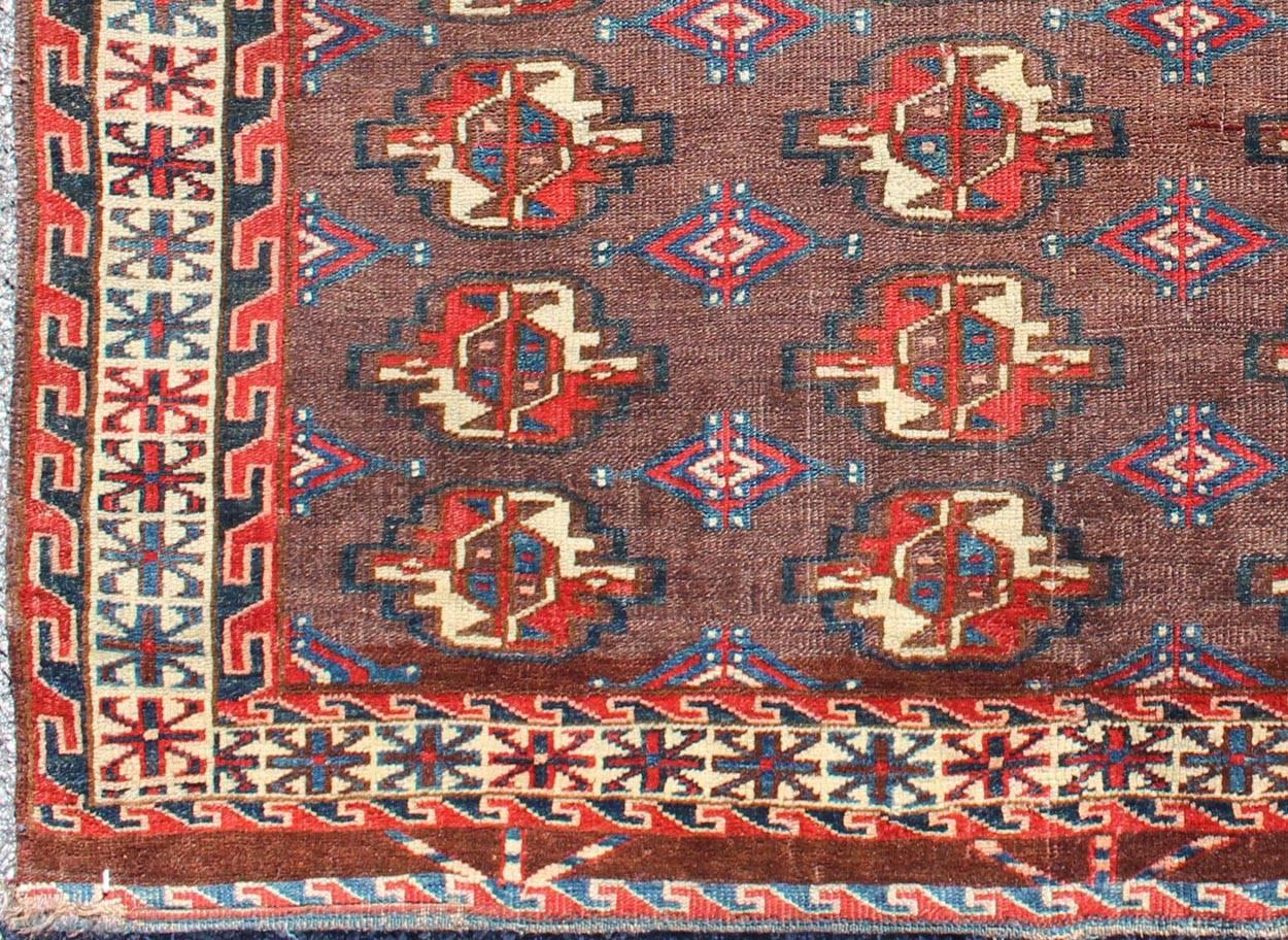 19th century antique Tekke rug with brown field and tribal motifs in red, rug g-1004, country of origin / type: Russia / Tribal, circa 1900

This piece is a rare antique Tekke carpet with delightful colors. The field consists of a chocolate brown