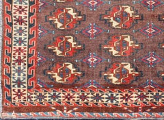 19th Century Antique Tekke Rug with Brown Field and Tribal Motifs in Red