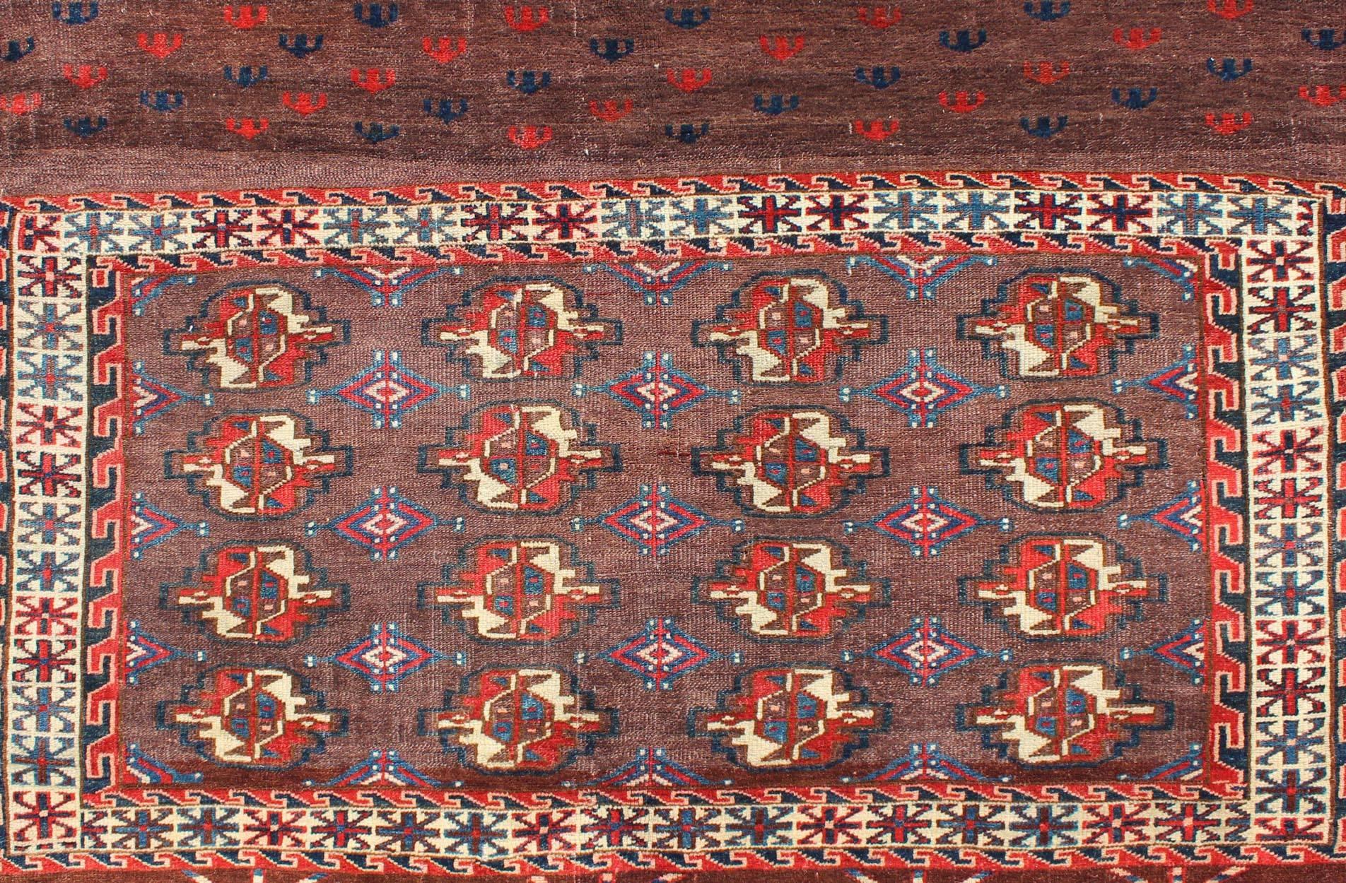 Turkestan 19th Century Antique Tekke Rug with Brown Field and Tribal Motifs in Red For Sale