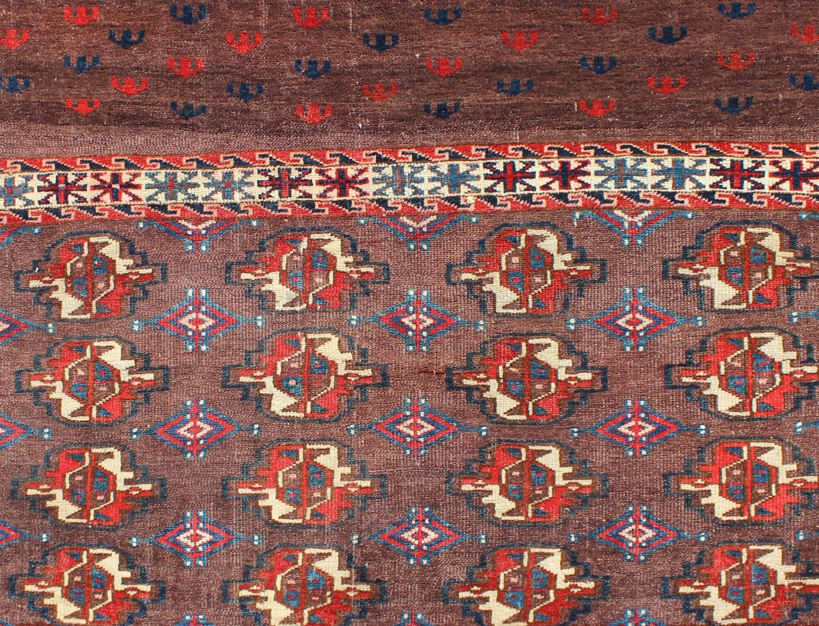 Hand-Knotted 19th Century Antique Tekke Rug with Brown Field and Tribal Motifs in Red For Sale