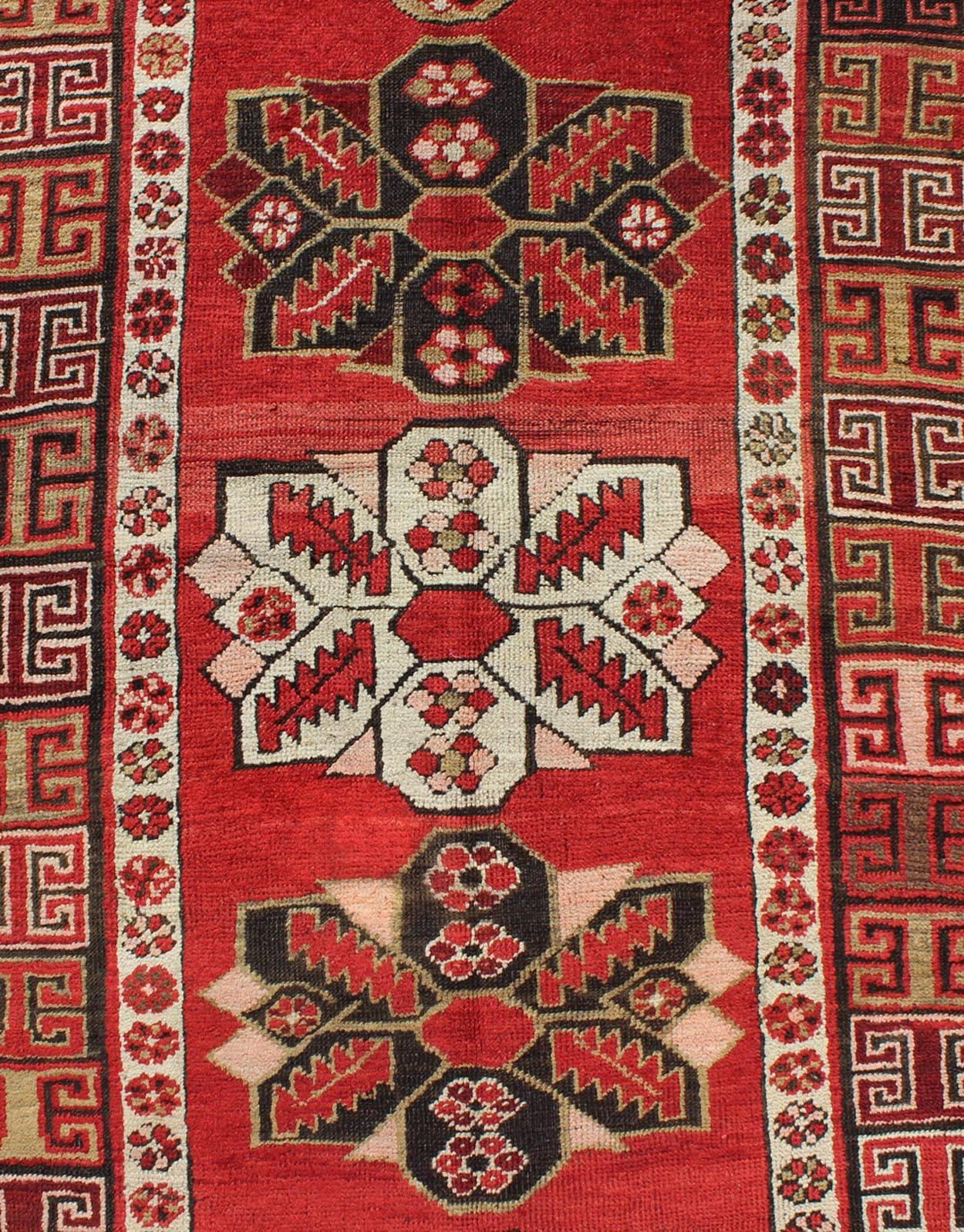 Hand-Knotted Antique Kazak Runner with Medallions and Tribal Design in Red Background  For Sale