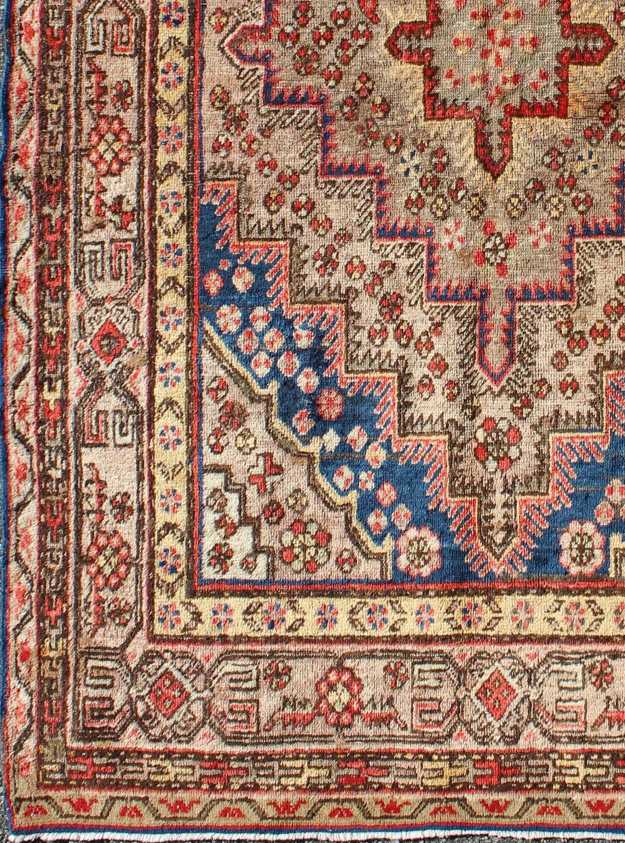 Multi colored background antique Khotan rug with layered medallions, rug mp-1301-434, country of origin / type: East Turkestan / Khotan, circa 1920

Measures: 4'8 x 6'6.

This exquisite antique carpet created in Khotan (circa 1920) features an