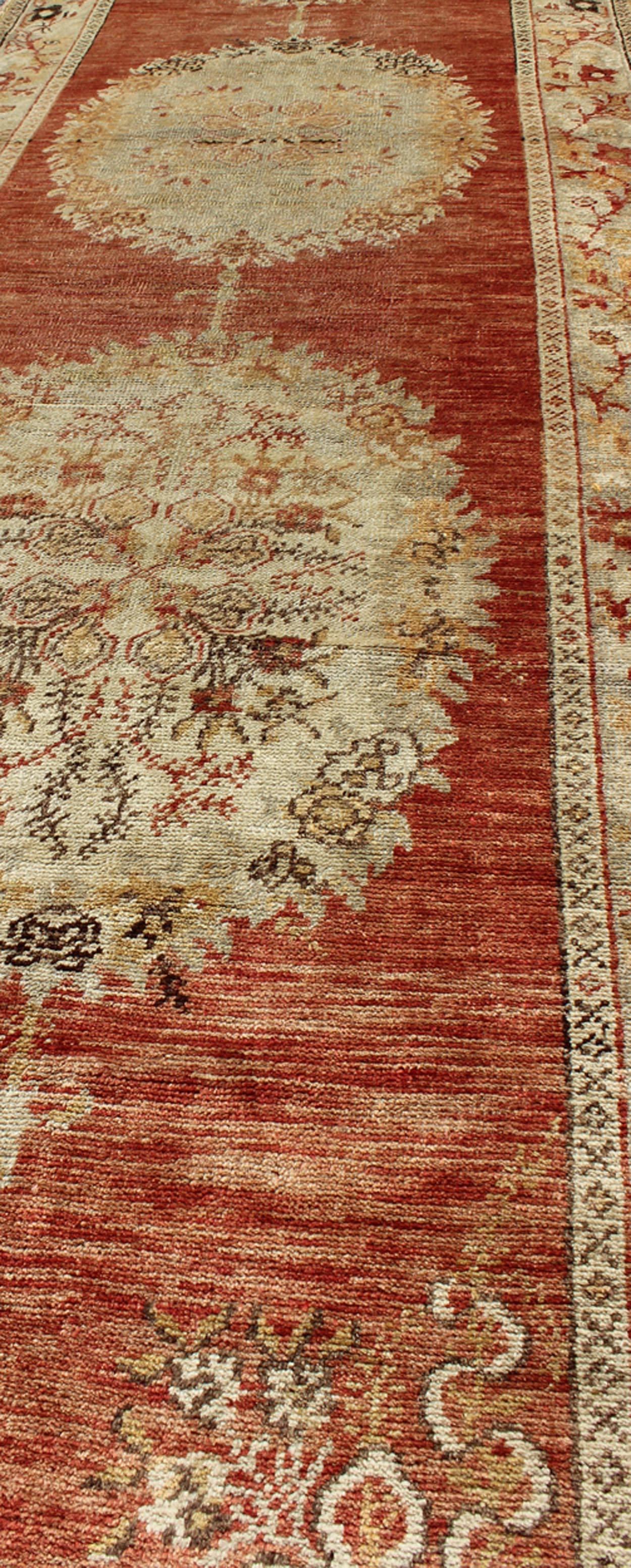 Oushak Runner With Floral Medallions in Soft Orange Red, Olive Green & Ivory In Excellent Condition For Sale In Atlanta, GA