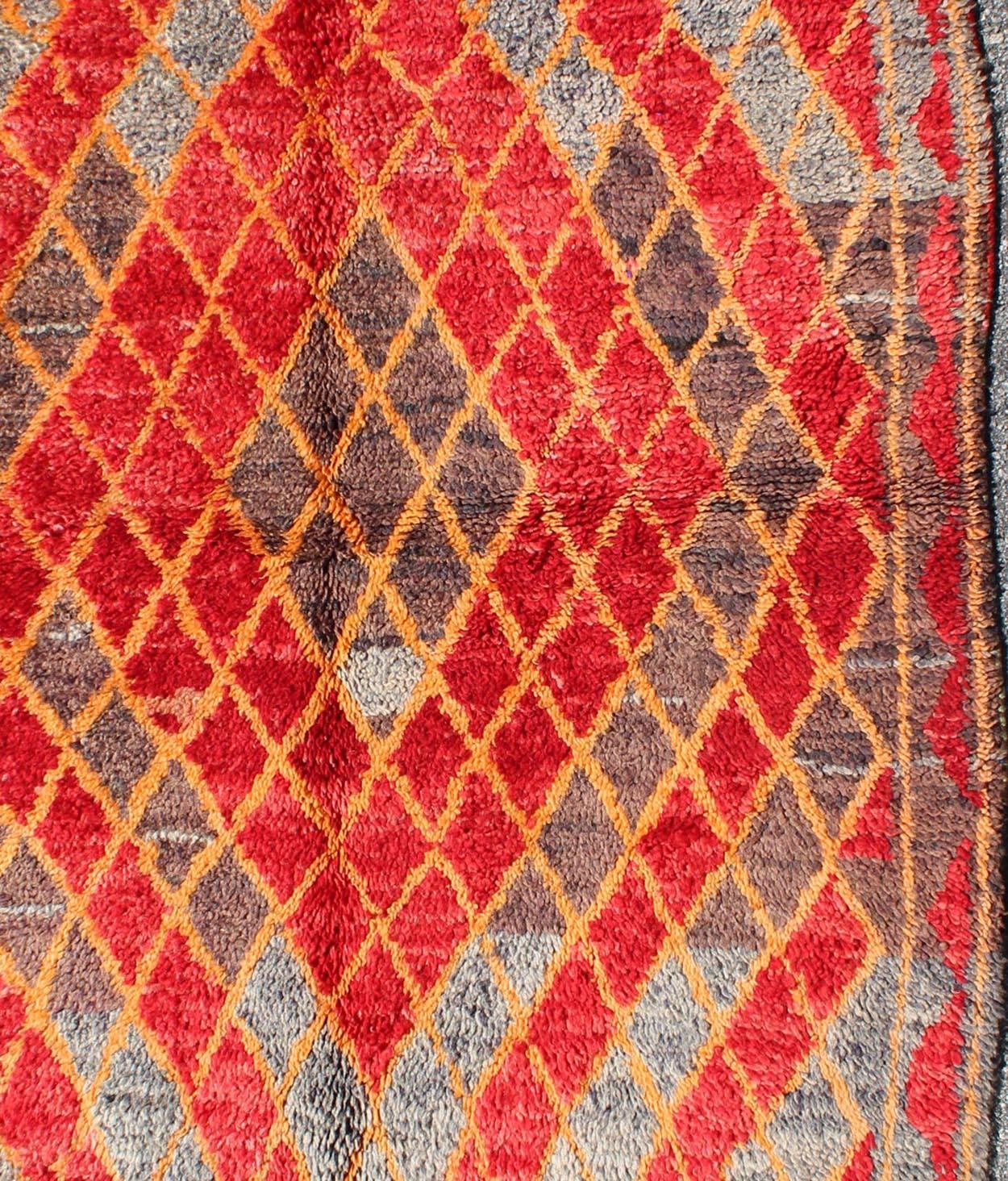 Hand-Knotted Midcentury Moroccan Rug with Orange, Red, Brown Diamonds and Blue Fringe Detail For Sale