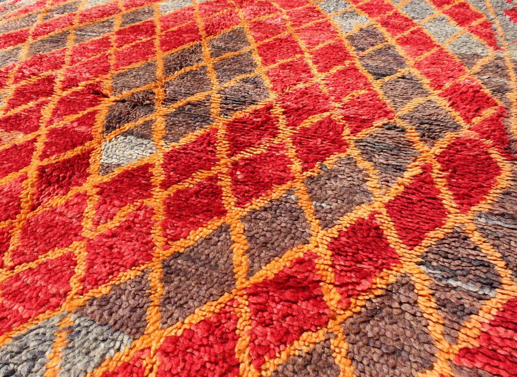 Midcentury Moroccan Rug with Orange, Red, Brown Diamonds and Blue Fringe Detail In Good Condition For Sale In Atlanta, GA