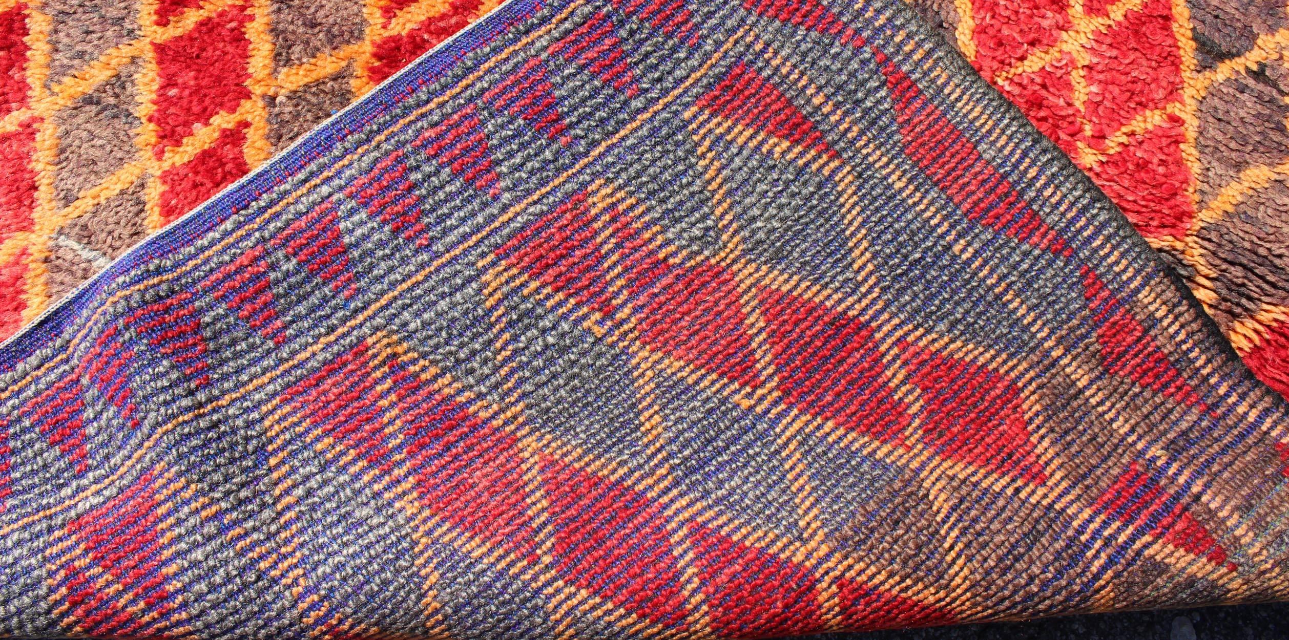 20th Century Midcentury Moroccan Rug with Orange, Red, Brown Diamonds and Blue Fringe Detail For Sale