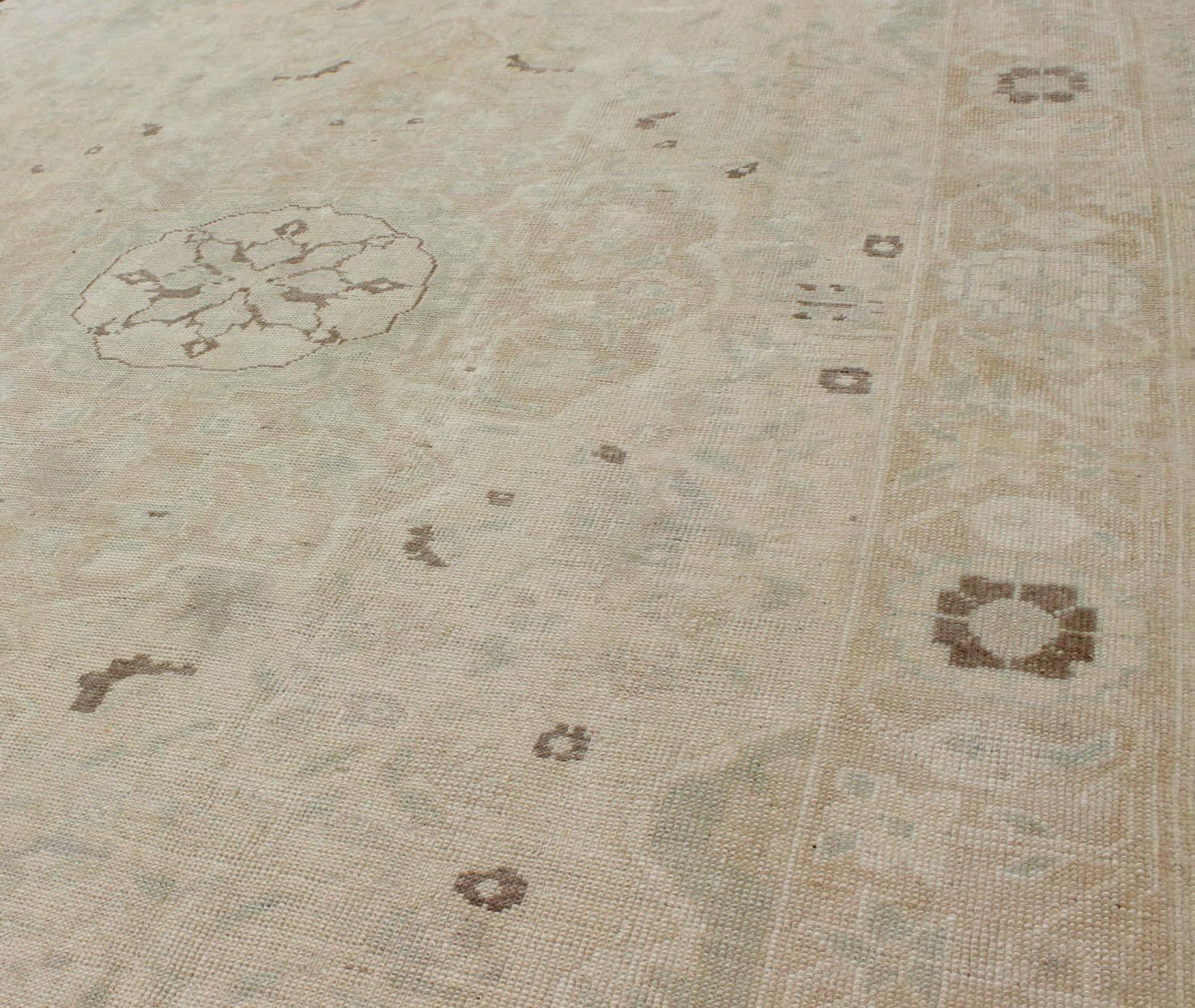 Muted Turkish Oushak Rug with Medallion in Shades of Taupe, Light Brown & Green In Good Condition For Sale In Atlanta, GA