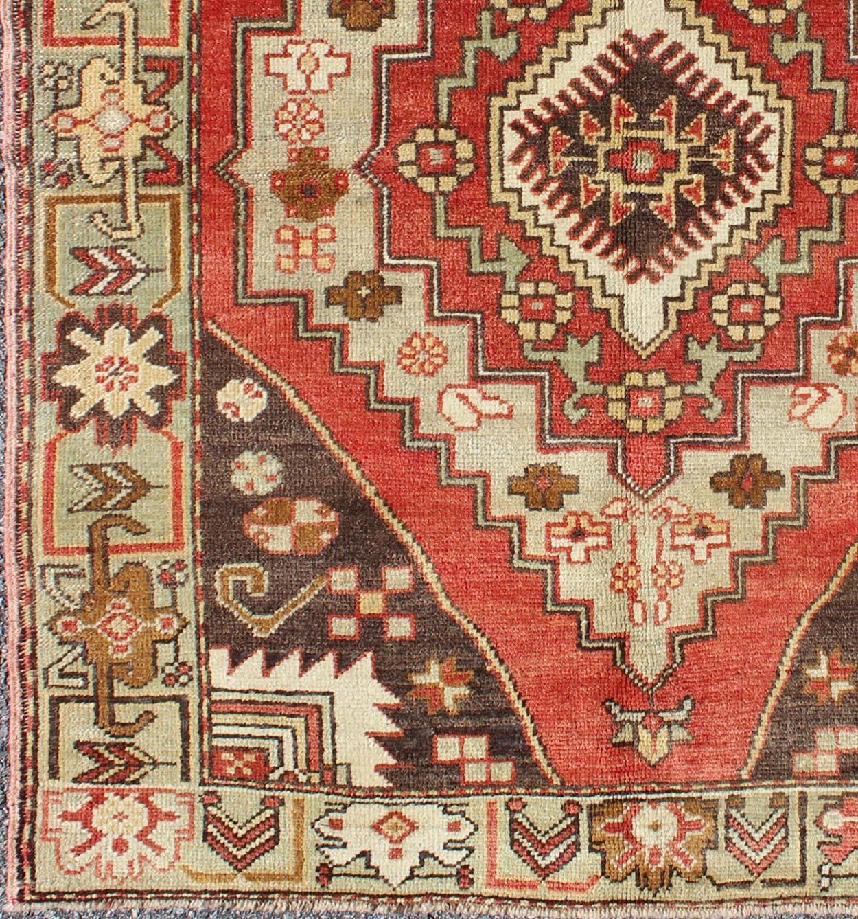 Multi-layered medallion vintage Turkish Oushak rug in red, brown, mint green, rug en-3914, country of origin / type: Turkey / Oushak, circa mid-20th century

This vintage Turkish Oushak rug (circa mid-20th century) features a unique blend of colors