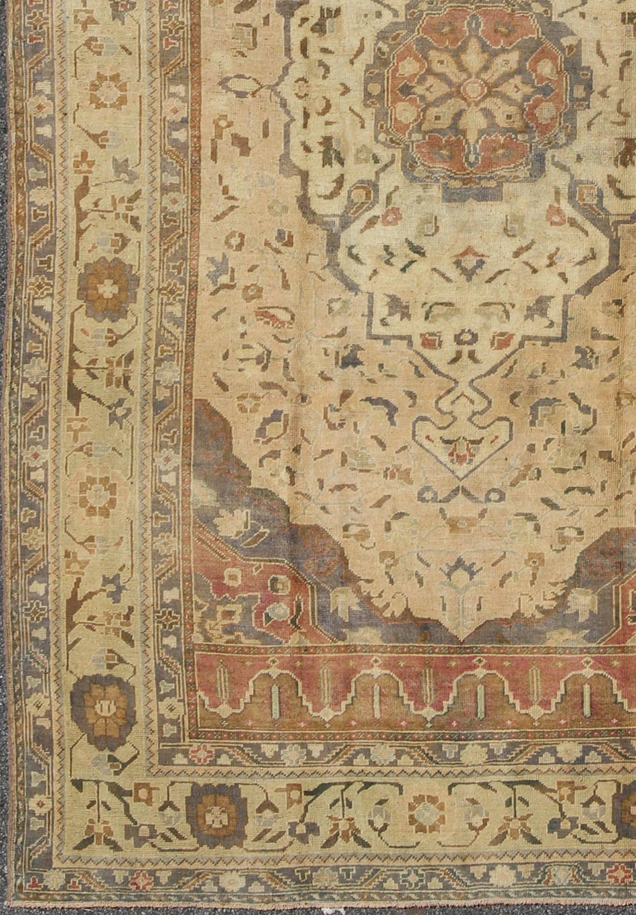 Turkish Oushak rug vintage with layered medallion in ivory, red, blue and olive, rug en-421, country of origin / type: Turkey / Oushak, circa mid-20th century.

This vintage Turkish Oushak rug (circa mid-20th century) features a unique blend of